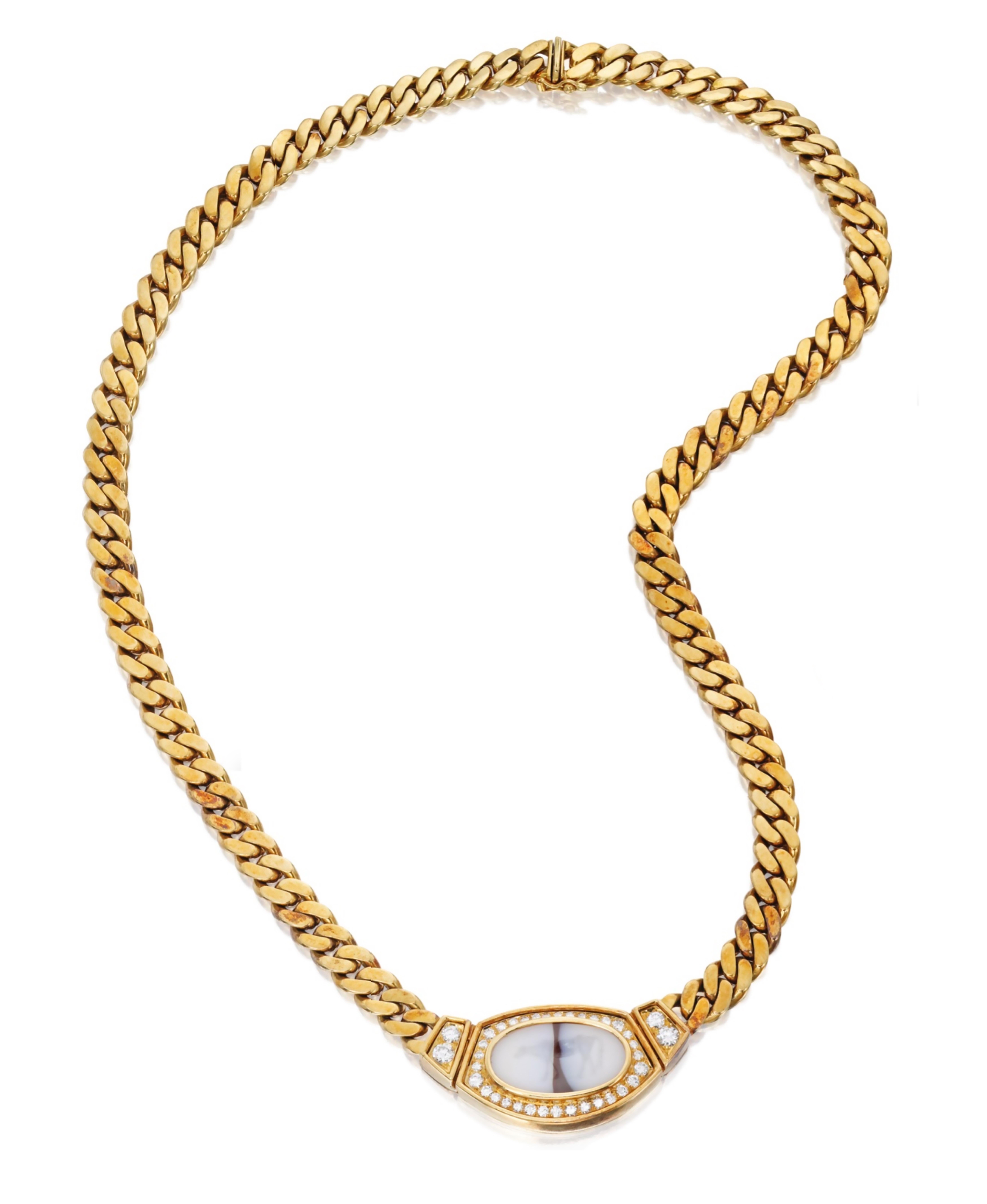 A chic Bulgari curb link chain necklace suspending an ancient intaglio depicting a cow, surrounded by round brilliant cut diamonds. Made in Italy, circa 1970, 18; karat yellow gold.