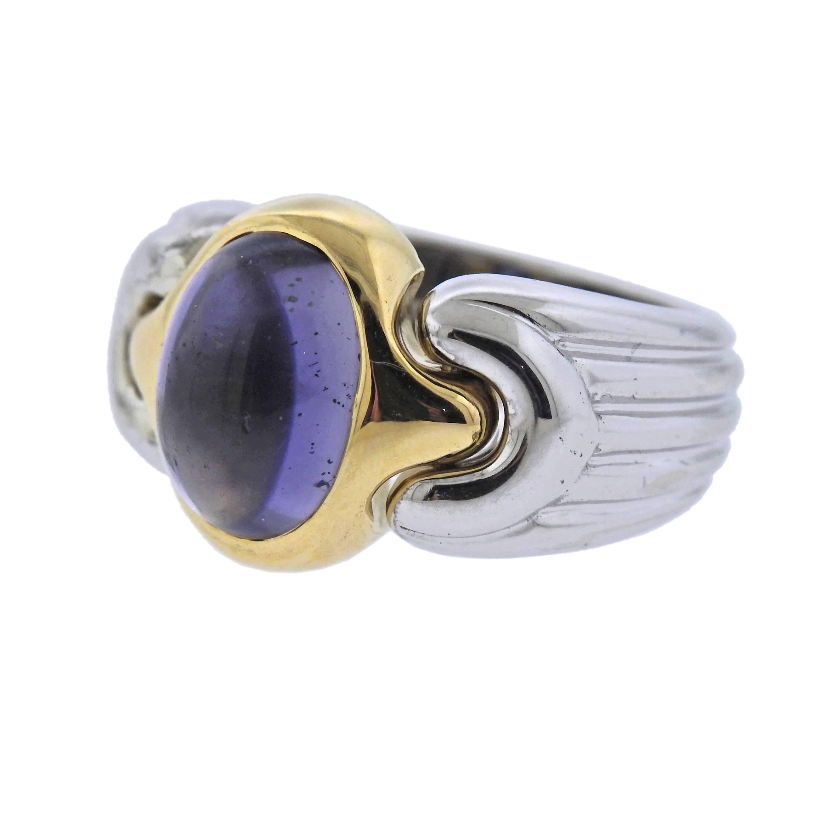 18k white and yellow gold ring by Bulgari, set with an 11mm x 8mm iolite cabochon. Ring size - 5, ring top is 13.6mm wide , weighs 13.5 grams. Marked: Bvlgari, 750, 2337AL.
