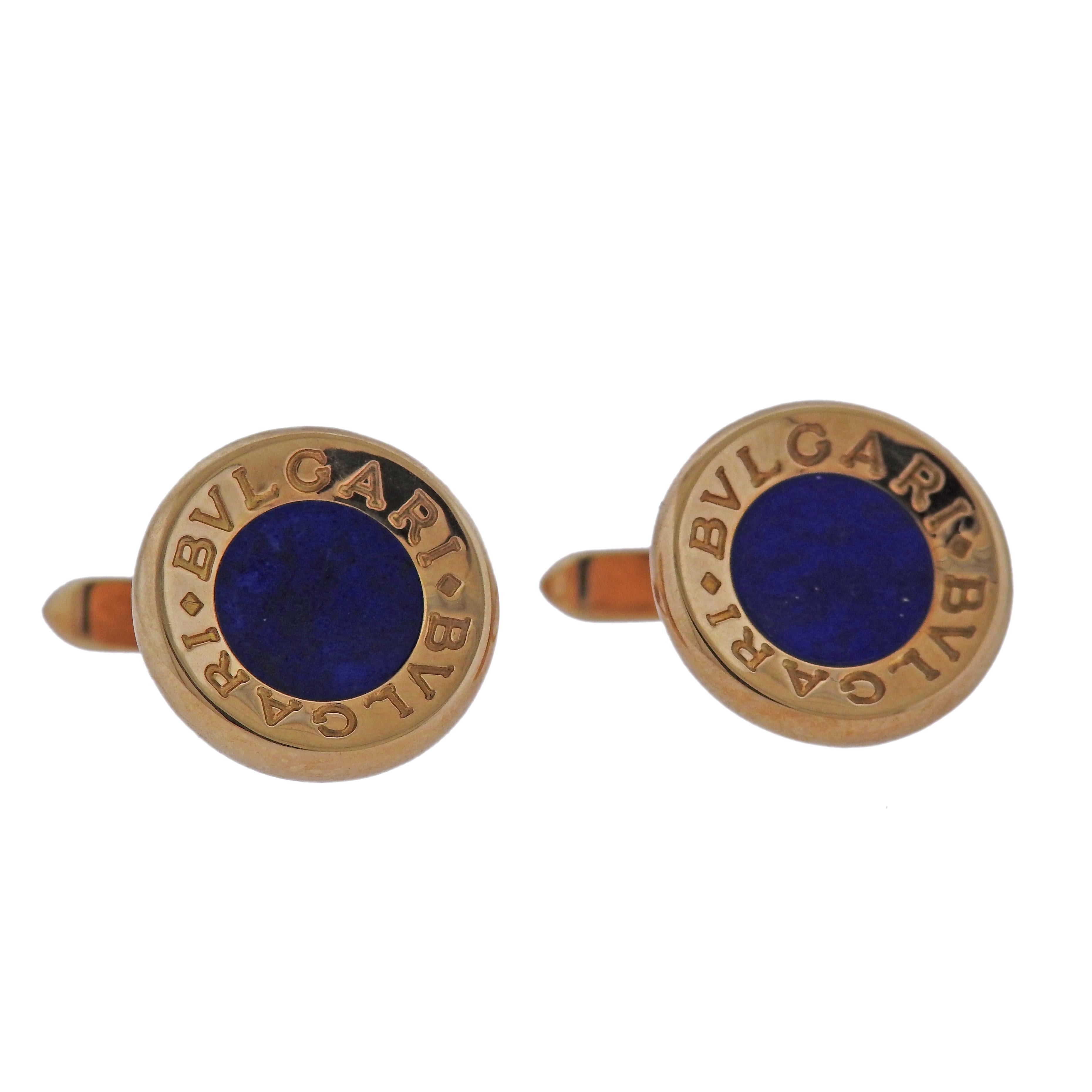 Pair of 18k yellow gold cufflinks by Bvlgari, set with 9mm lapis lazuli. Cufflink is 16mm in diameter. Weigh 19.1 grams. Marked: Bvlgari, 750, made in Italy.