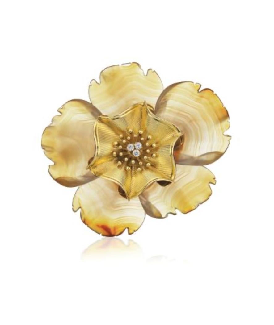 A large flower petal brooch in carved agate and gold, highlighted with diamonds, by Bulgari, circa 1960.
