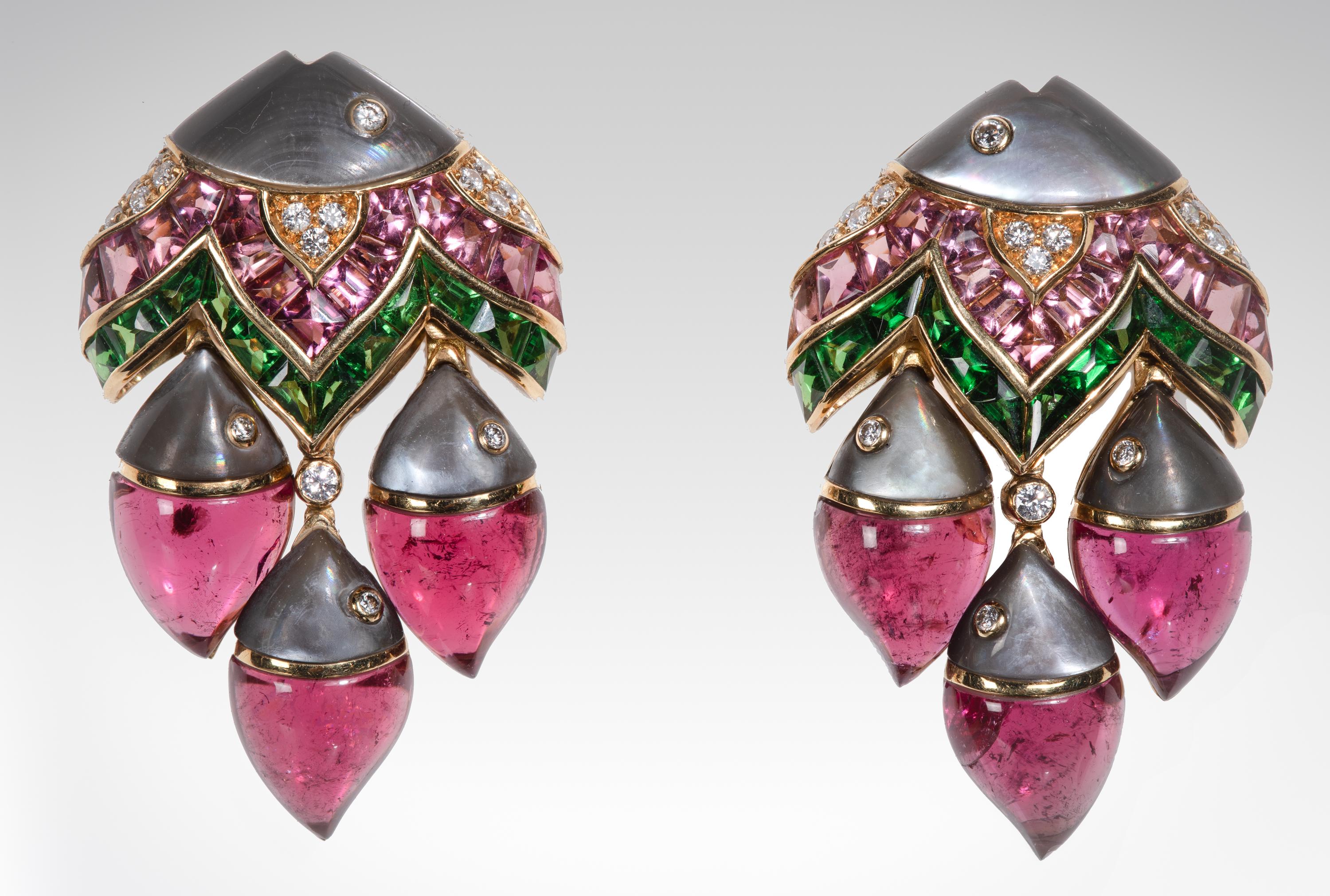 Illustrating Bulgari’s masterful color sense and flamboyant style, these “Mamma Pesce” articulated drop earrings are designed as a large stylized fish suspending three smaller fish. The mother fish is composed of pink tourmalines, tsavorite garnets,