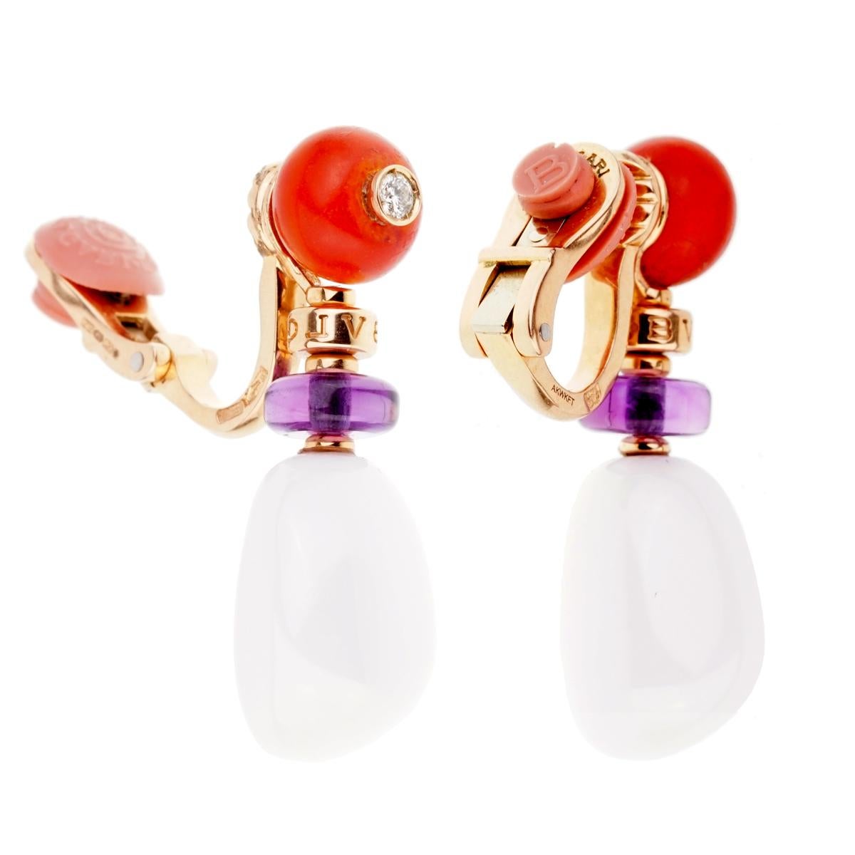 A magnificent pair of Bulgari Mediterranean Eden earrings featuring coral, amethyst, and white agate enhanced with a beautiful round brilliant cut diamond in the coral set in 18k rose gold.

Width: .50