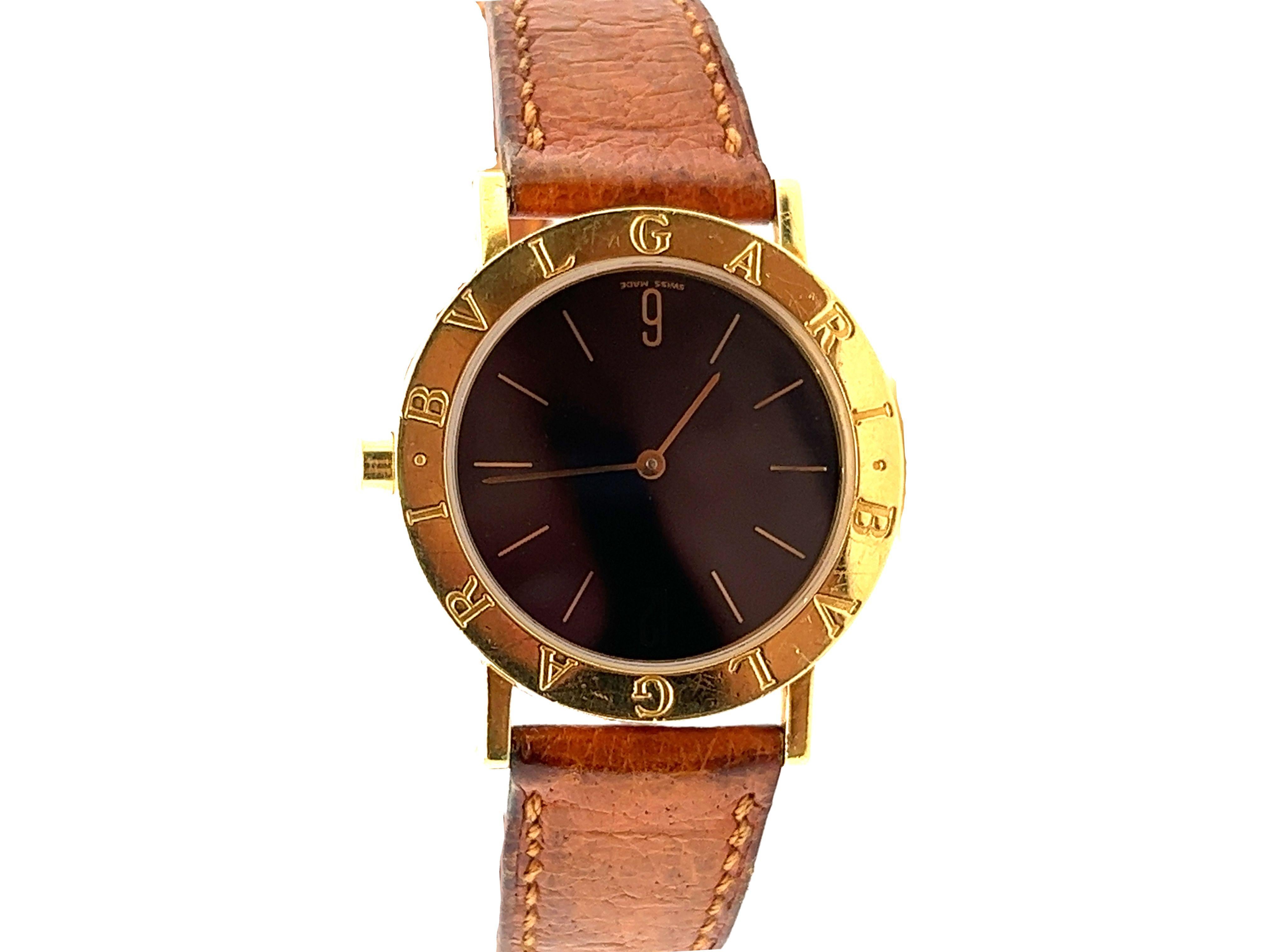 Bvlgari 18k yellow gold 33m case men's watch with leather strap. Reference Bb30 GI, serial G14112, with quartz movement, black dial, golden stick hour markers
and the legendary 