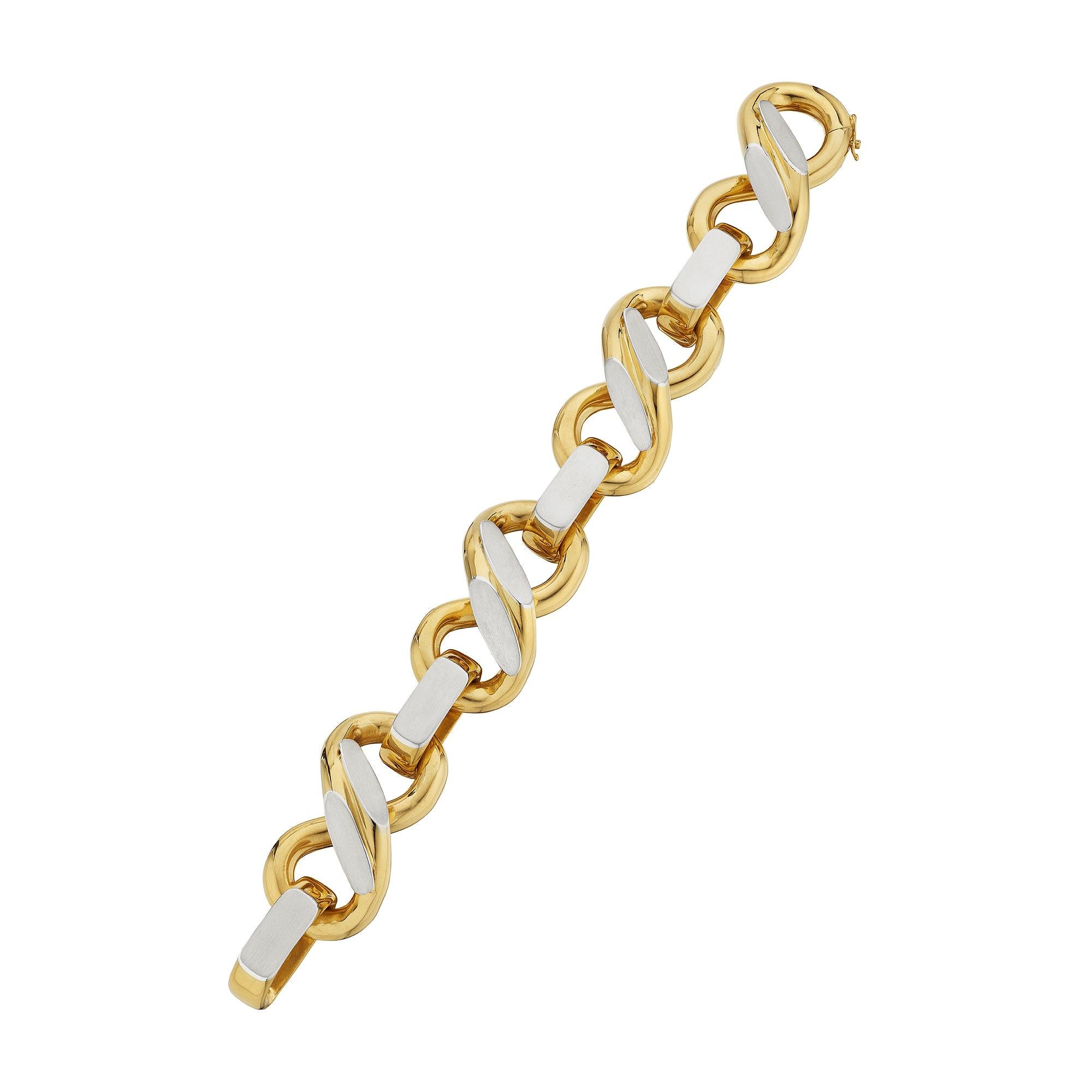 Bold and bountiful, this Bulgari modernist bi-colored white and yellow gold bracelet is the ultimate statement piece.  With four full and rounded figure-eight 18 karat yellow gold links contrasted with eight applied 18 karat white gold flat oval