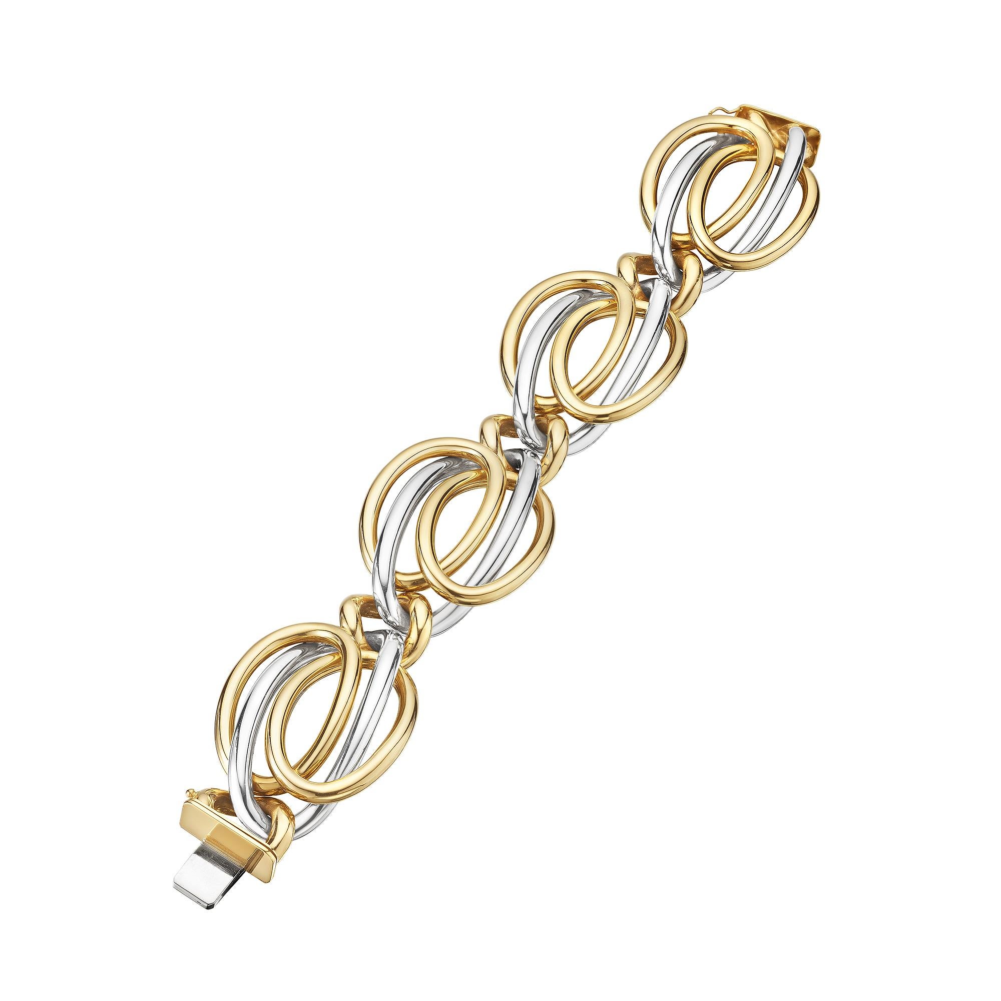 Sensually contoured, collectible, and eye-catching this Bulgari modernist 18 carat yellow and white gold intertwined large oval link bracelet is simply irresistible.  Signed Bulgari.  Circa 1975.  7 1/2