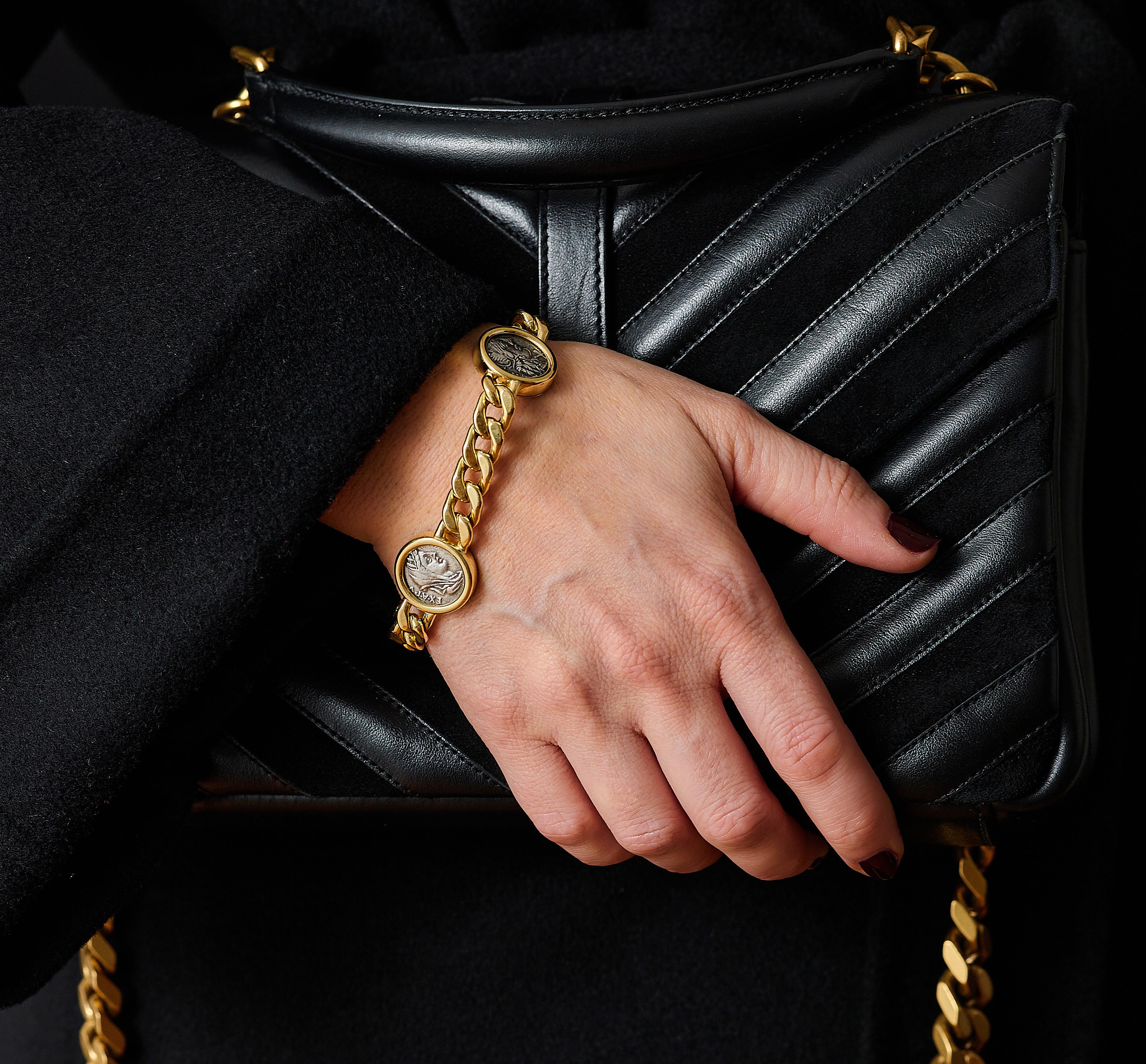 Bvlgari Monete Ancient Coin 18k Gold Bracelet

The ancient silver coins are bezel-set in a clean and simple gold frame with a high polished finish connected by a signature curblink chain. 

Three coins on a classic 18karat curb link. Gross weight