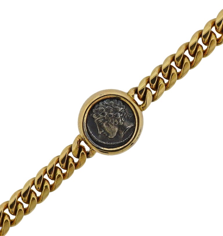 Bvlgari 18k gold bracelet, set with three ancient coins.  Bracelet is 7 1/4
