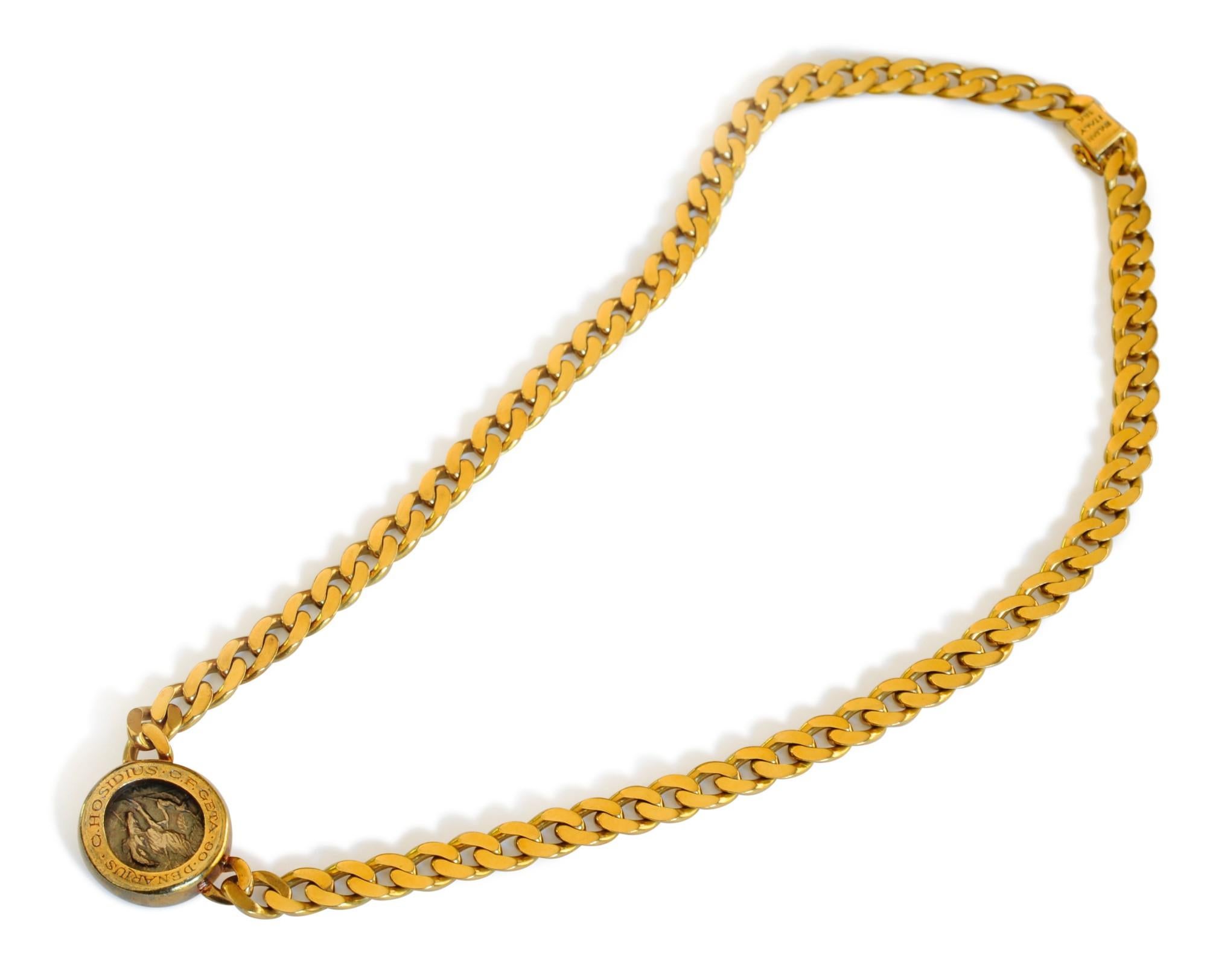 A classic Bulgari Monete piece featuring a bezel-set ancient Roman coin, the bezel reverse inscribed ‘Hosidius C.F. Geta 90 Denarius,' suspended from an 18 karat gold curb link chain. Length 15½ inches. Made in Italy.