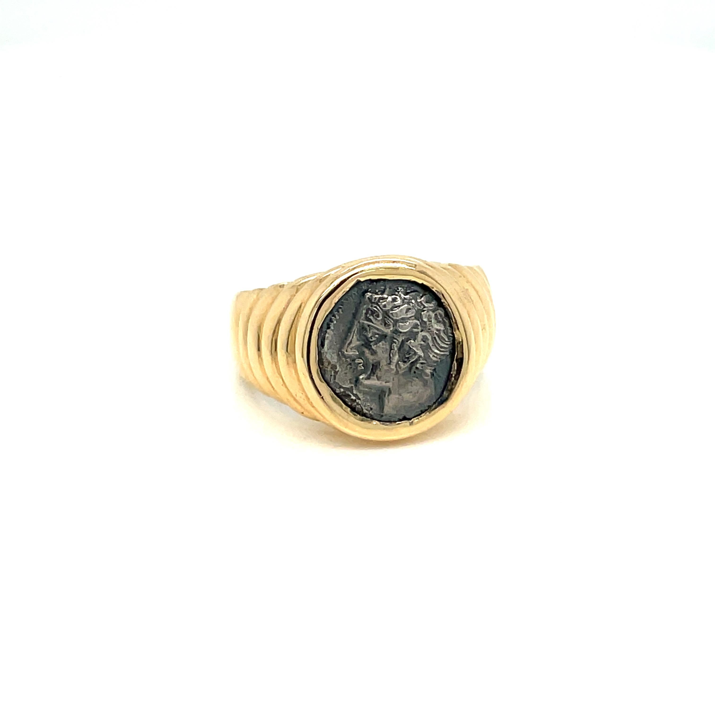 Bulgari 18k gold ring from Monete collection, featuring ancient Gallia Massalia silver coin. Showing Apollo just how alluring a 2.000-year-old coin can look when combined with a bold, contemporary setting, today the Monete ring captures the eternal