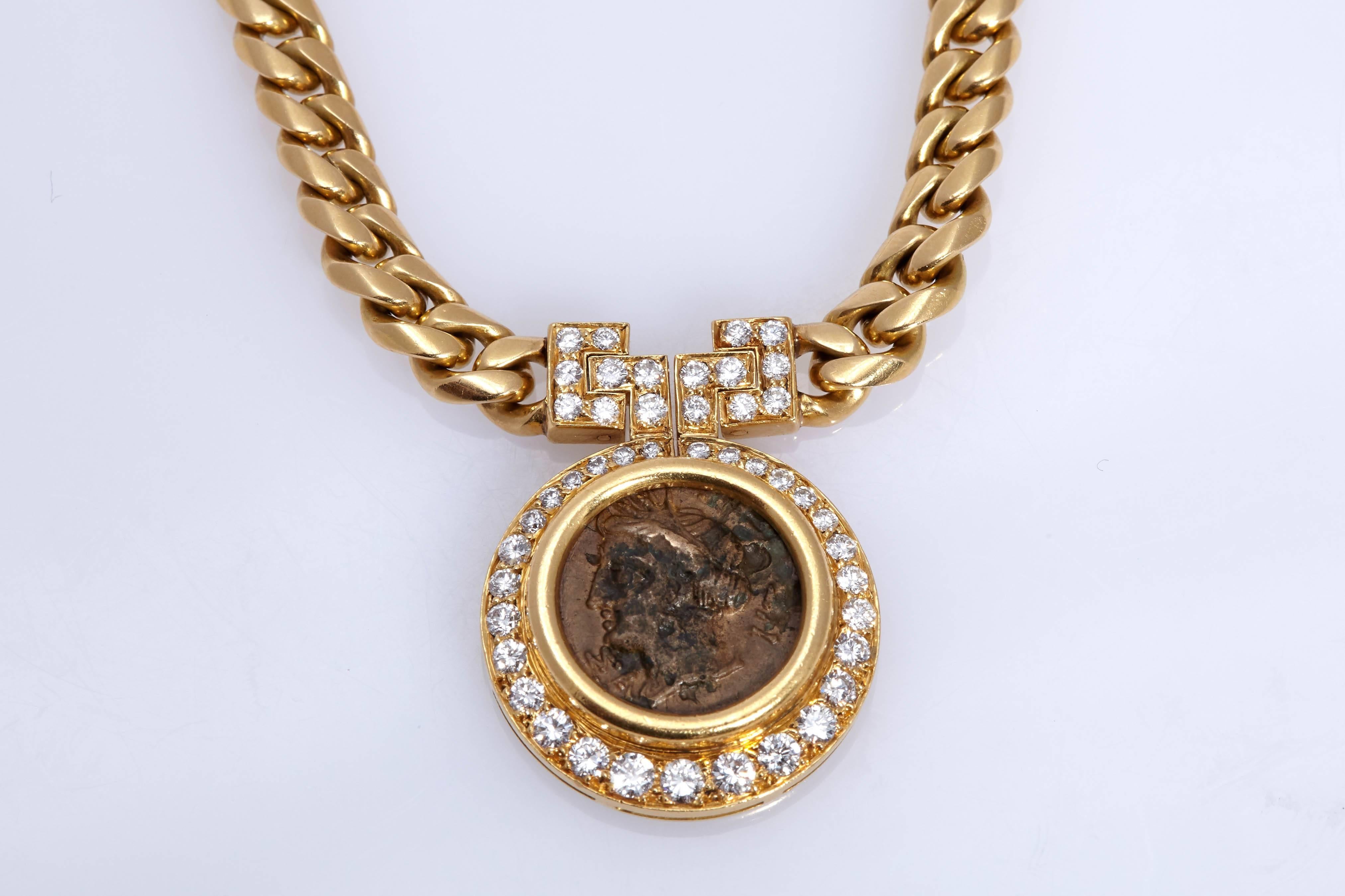 A Bulgari 18kt yellow gold curb link chain necklace suspending an antique Roman coin pendant surrounded by diamonds. Made in Italy, circa 1970s