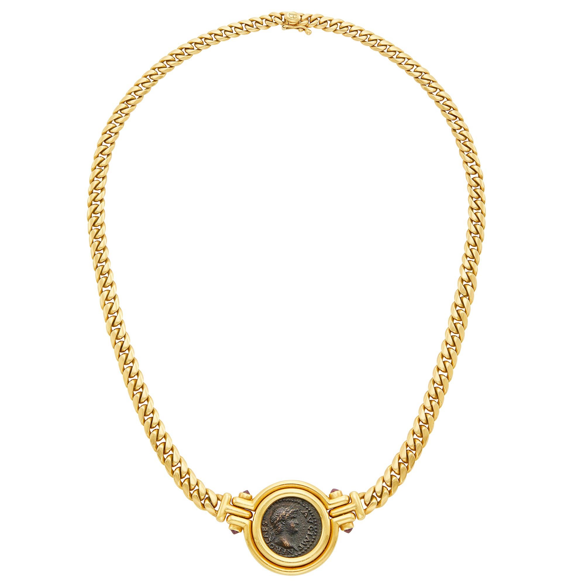 Bulgari Gold, Cabochon Ruby and Roman Coin 'Monete' Pendant-Necklace, Bulgari
18 kt., centering an ancient coin, engraved on reverse 'Roma-Nero 54-68', flanked by 4 round domed cabochon rubies, sustained by a curb link necklace. Made in Italy, circa