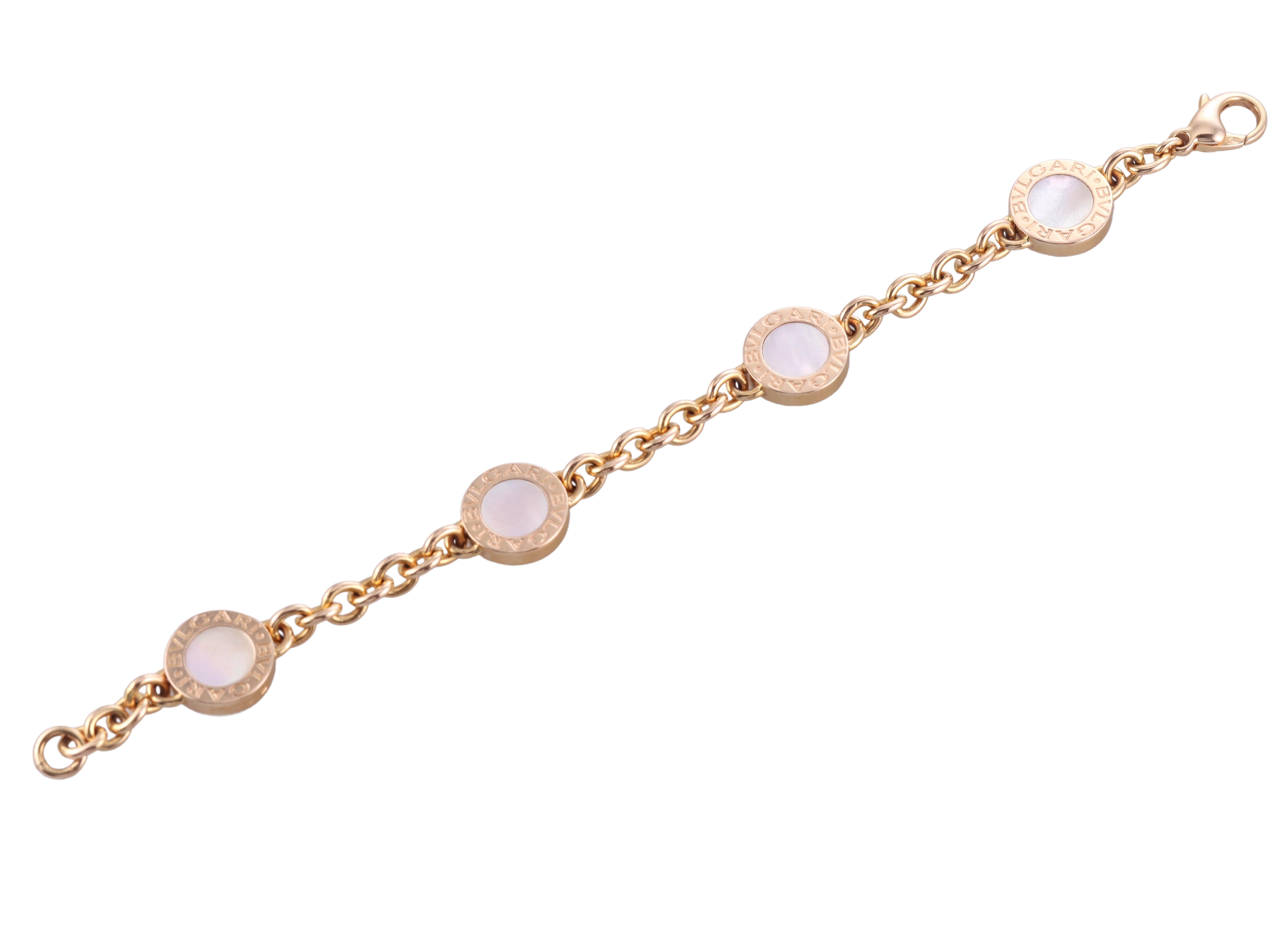 18k rose gold Bvlgari bracelet, featuring four two sided circle links, with mother of pearl and onyx. Bracelet is 6.75