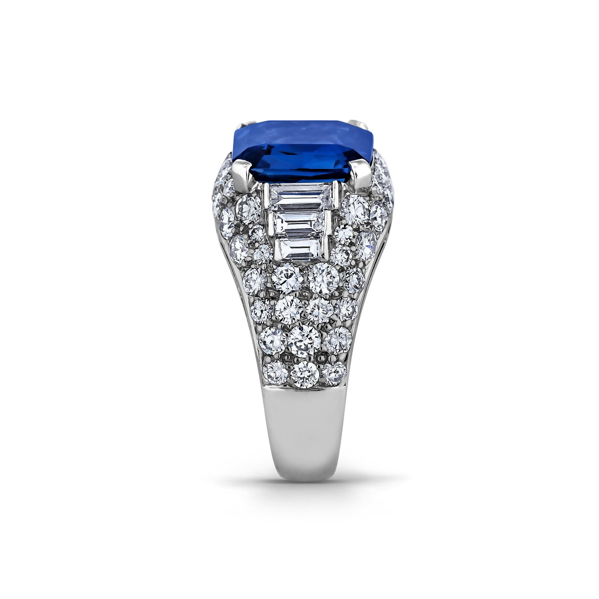 
A vibrant velvety blue natural no heat certified 3.75 carat emerald cut sapphire is the striking centerpiece of this extraordinary Bulgari vintage ring.  Surrounded by a total of 1.80 carats of baguette and round brilliant cut diamonds and mounted