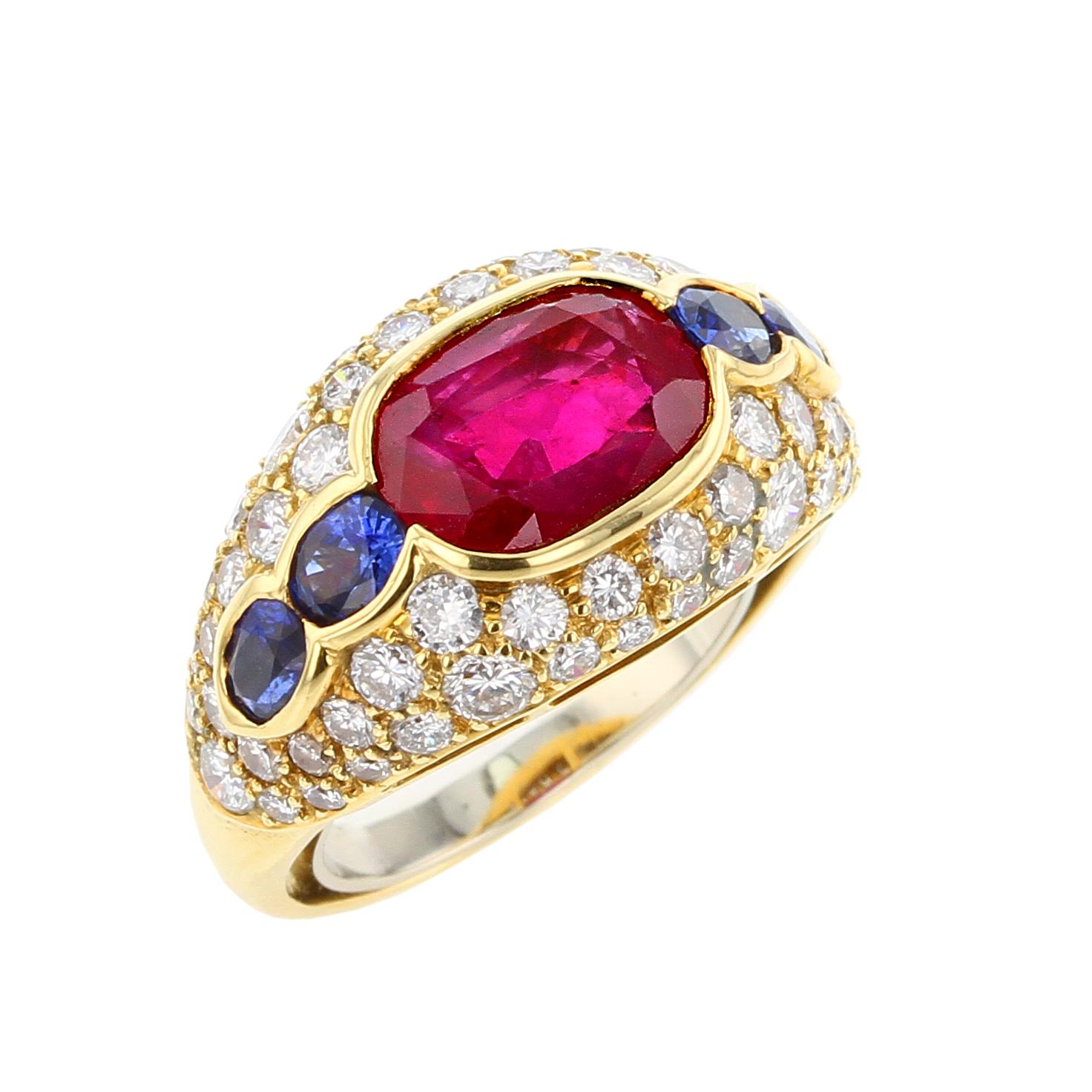 The Bvlgari ring features an oval-shaped burma ruby no heat measuring 9.85 x 7.00 x 4.28 mm and weighing 3.20 carats, flanked by oval-shaped sapphires approximately 0.75 carat, accented by brilliant-cut diamonds weighing a total of approximately