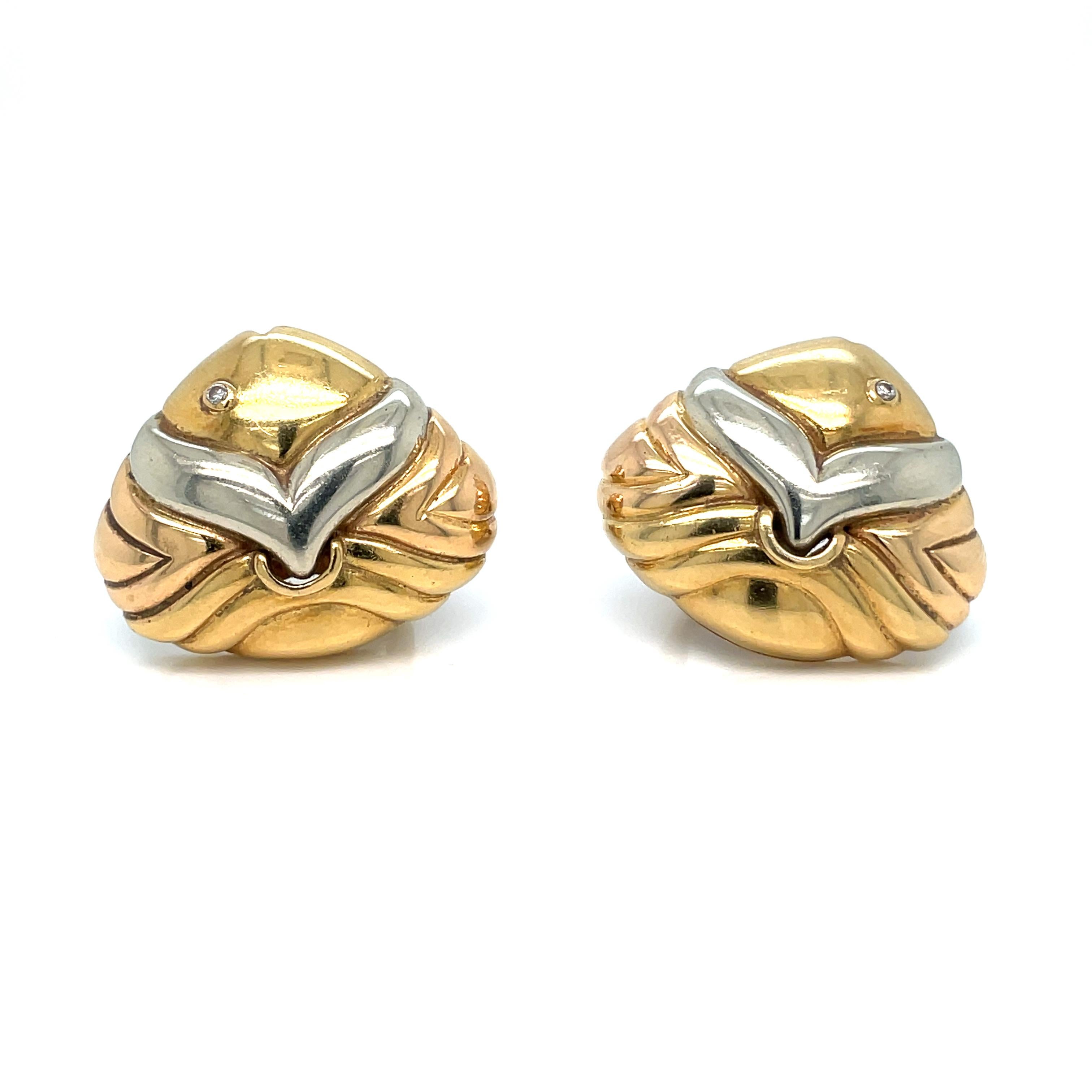 Pair of Tricolor Gold and Diamond Fish Earclips, Bulgari
18 kt. yellow, rose and white gold, the modified triangular-shaped fluted gold earclips depicting a stylized fish's head, centering 2 small round diamond eyes.

Excellent condition,
