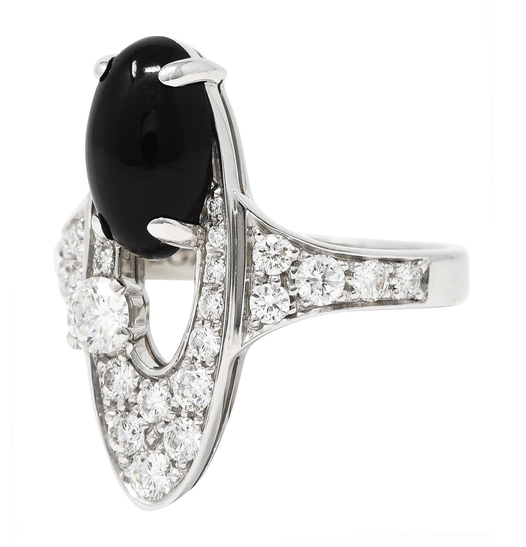Ring is designed as an elongated ellipse shape with an open center

Featuring an oval onyx cabochon measuring approximately 11.0 x 6.0 mm

Opaque black with very good polish

Paired with a round brilliant cut diamond weighing approximately 0.18