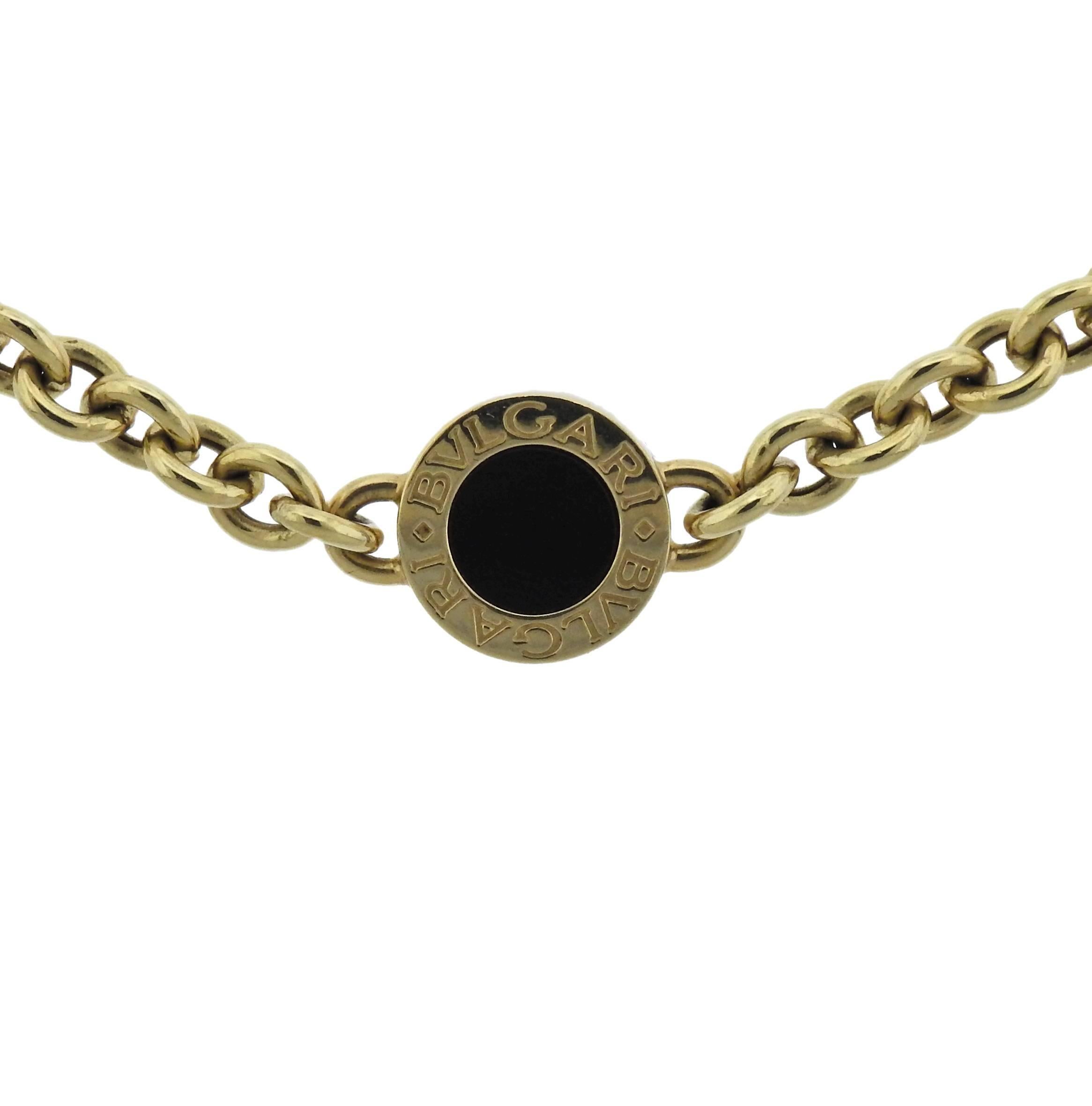 18k yellow gold station necklace, crafted by Bvlgari, decorated with onyx.  Necklace is 15.5