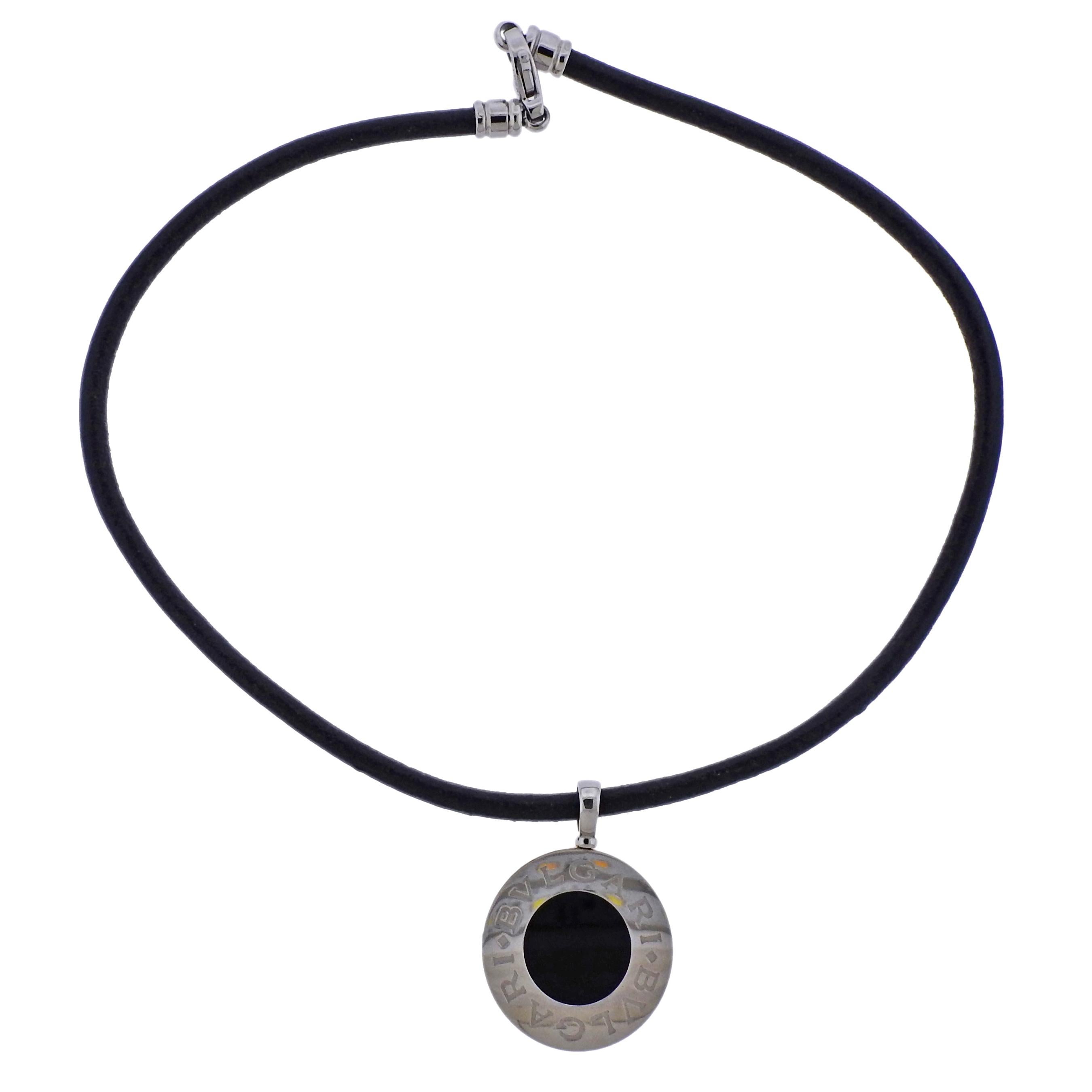 18k gold and stainless steel two sided pendant on a leather cord necklace, crafted by Bvlgari, featuring 19mm nephrite and onyx.  Necklace is 19.5