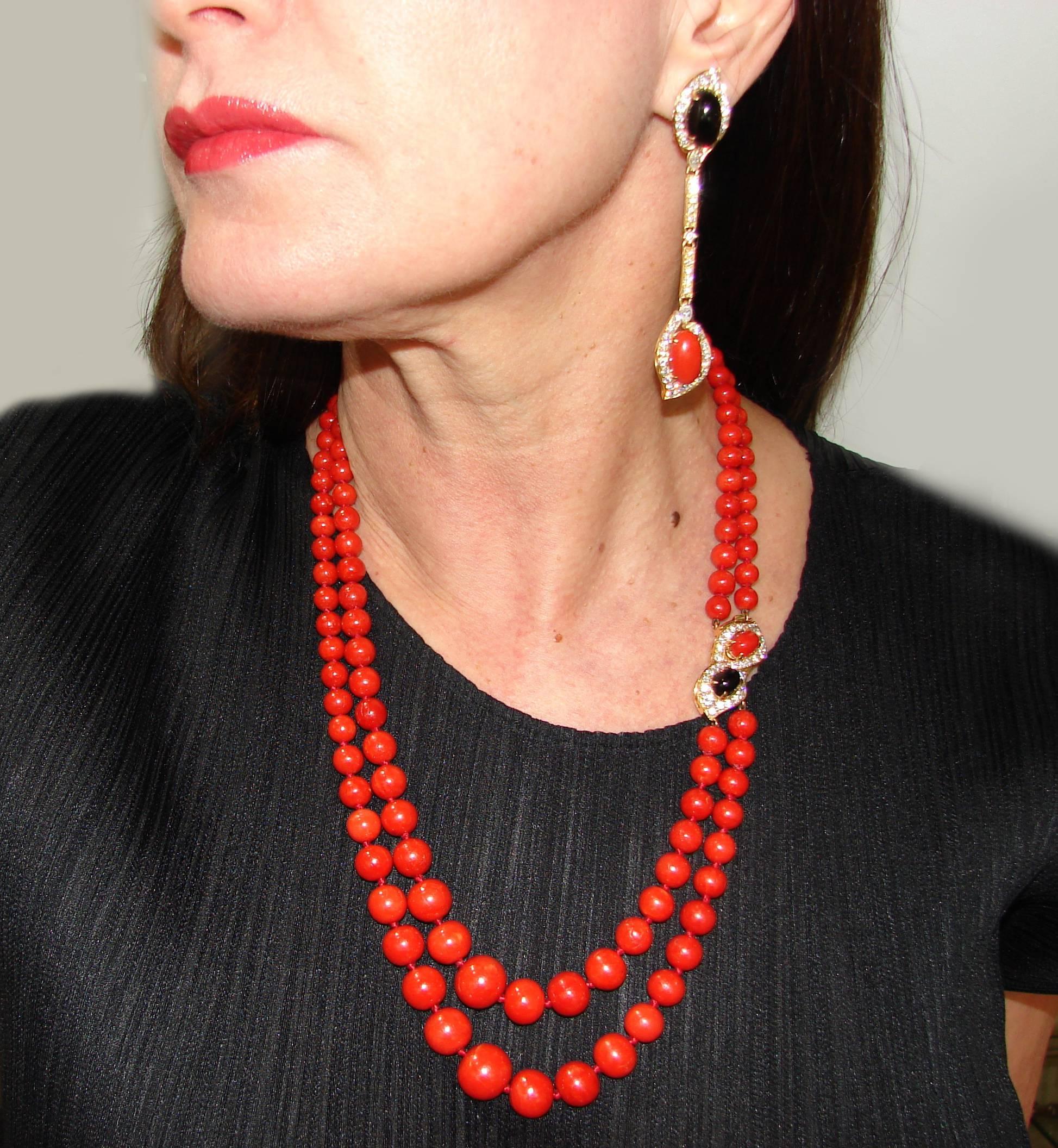 Gorgeous set consisting of a necklace and a pair of earrings created by Bulgari in Italy in the end of 1970's. Features finest quality oxblood Mediterranean coral beads culminating with an 18 karat yellow gold clasp encrusted with round brilliant 