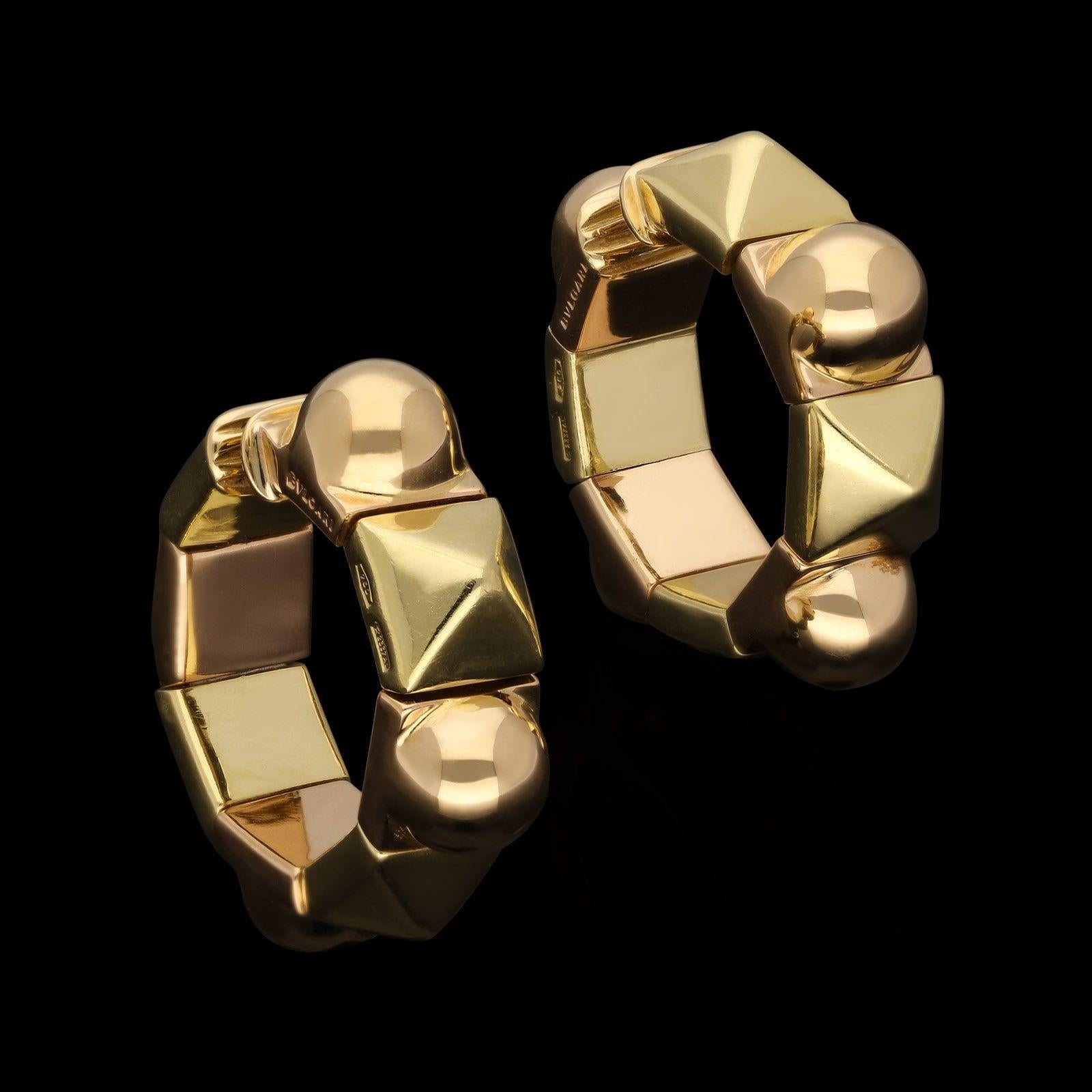 A stylish pair of vintage two-tone gold earrings by Bulgari c.1980s, each hoop approximately 1” in diameter and formed of alternating square shape links in either 18ct yellow gold with pyramid top or 18ct rose gold with a circular domed top, the