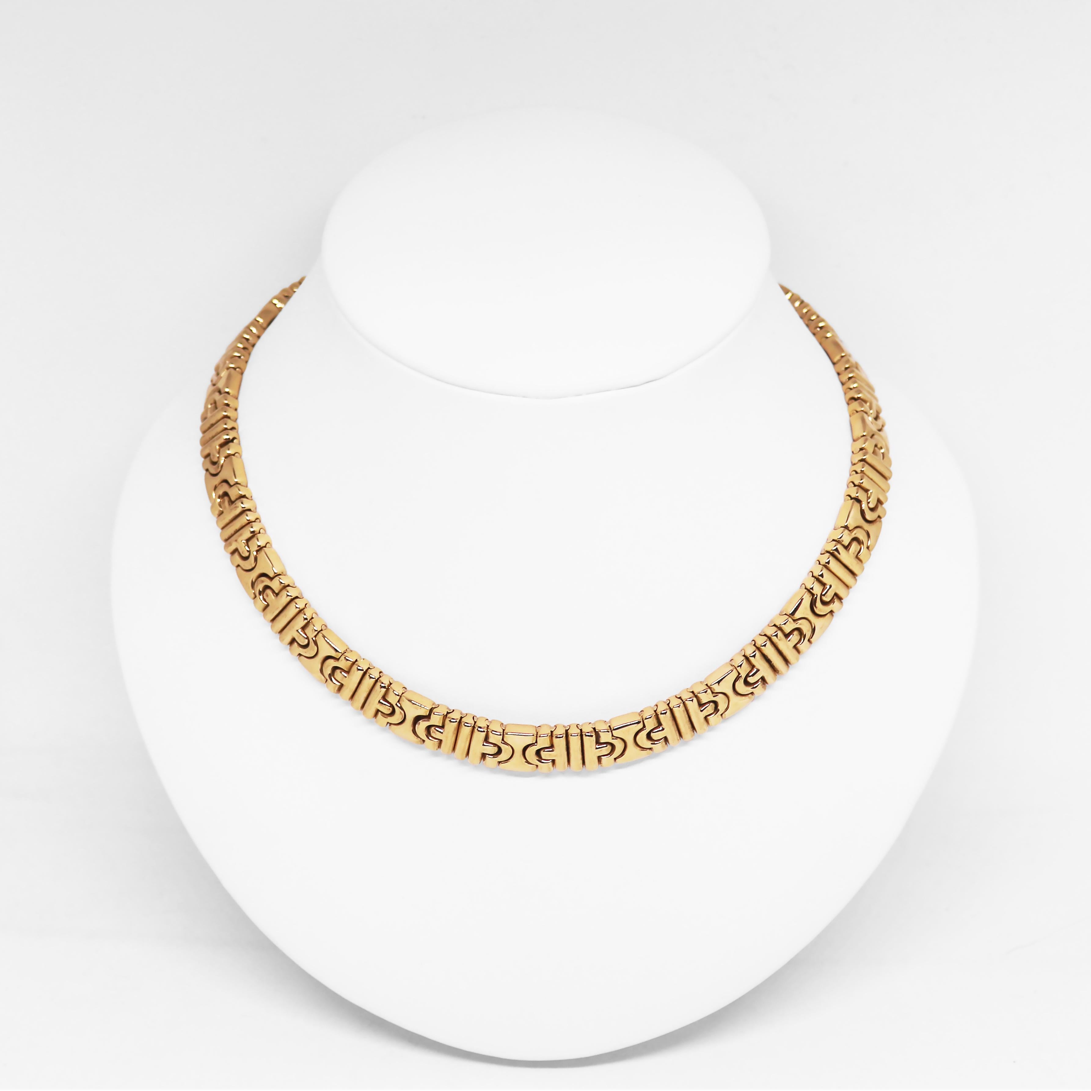 This iconic Bvlgari Parentesi 18 carat yellow gold necklace is composed of sculpted geometric links. The necklace measures 9.4mm in width and measures 16 inches in length. Signed Bvlgari, *2337AL. Italian hallmarks. Stamped 750. Circa 1988. 