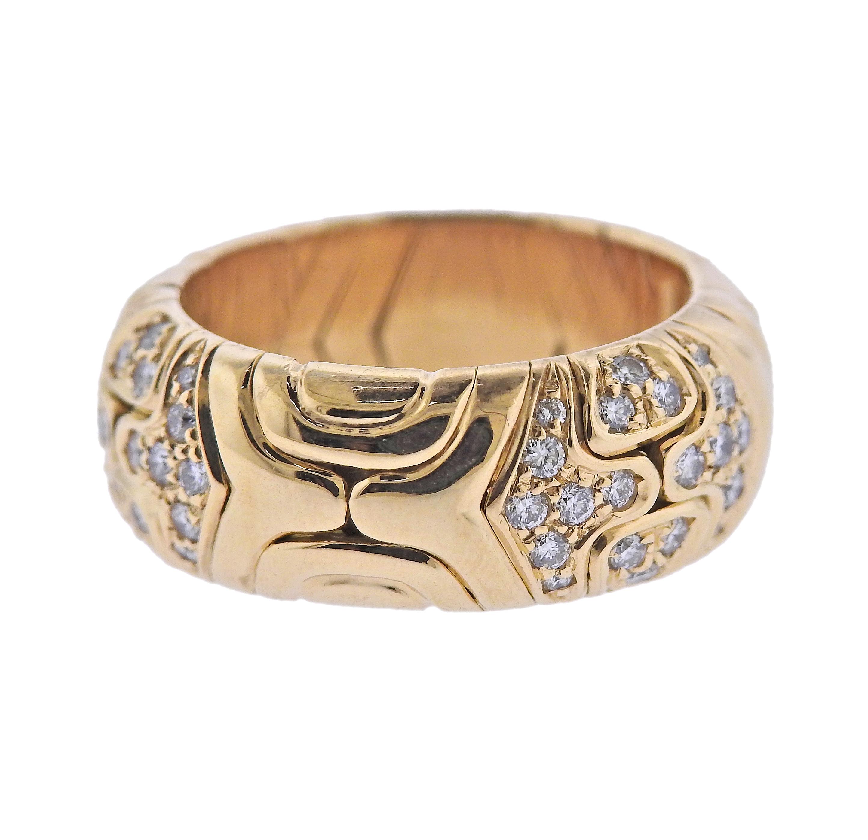 18k yellow gold band ring from signature Parentesi collection, by Bvlgari. Set with approx. 0.60ctw in G/VS diamonds. Ring size 6.5, width 8.3mm. Marked: Bvlgari, made in Italy, 750, 1989, Italian mark. Weight - 13.1 grams.