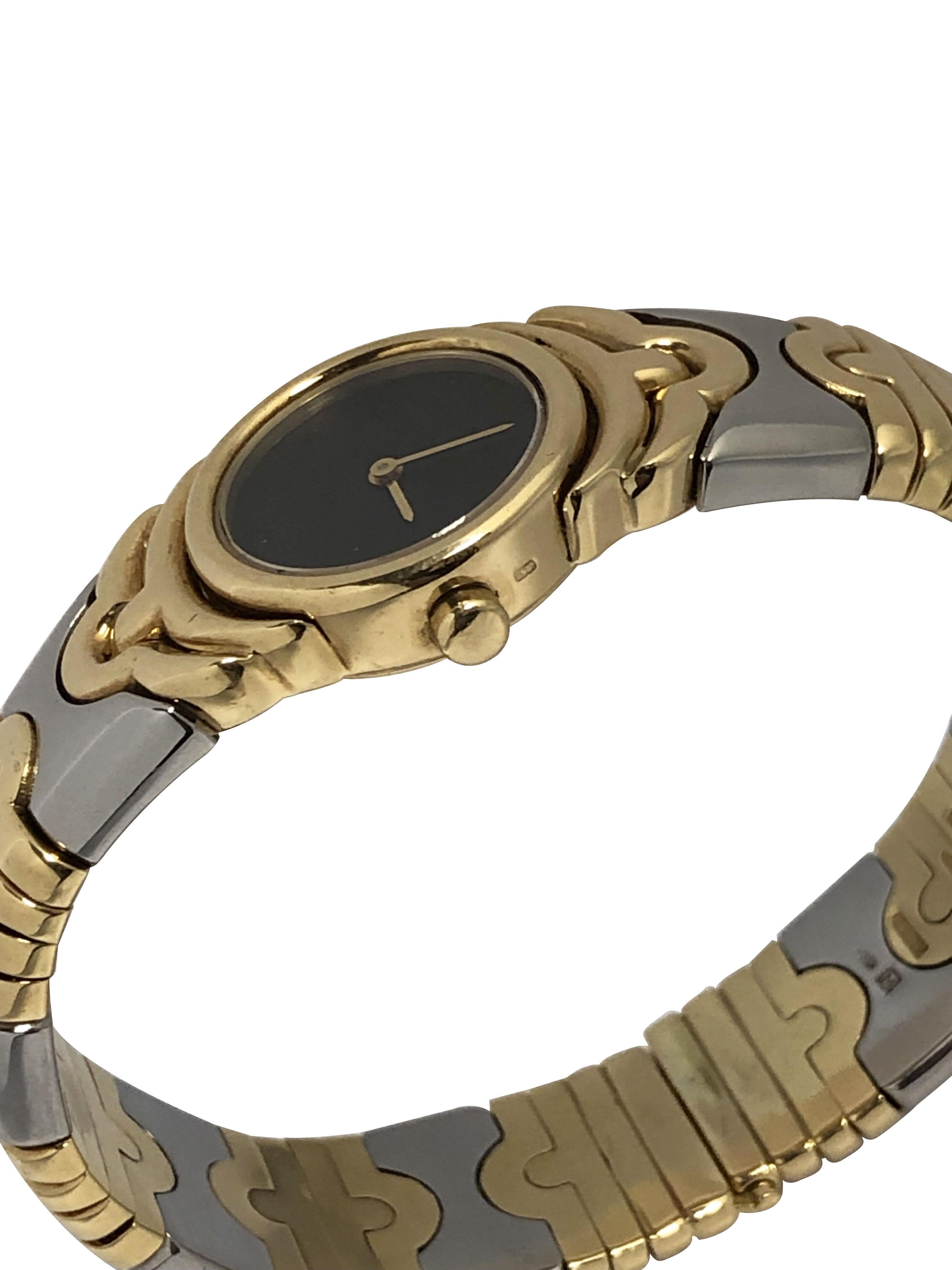 Circa 2000 Bulgari Parentesi ladies Wrist Watch, 20 M.M 18k Yellow Gold 2 piece case, Quartz movement, Black Dial with Gold Hands. 9/16 inch wide Parentesi 18k Yellow Gold and Steel Bracelet with a hidden slide closure. Wrist size 7 inches.
