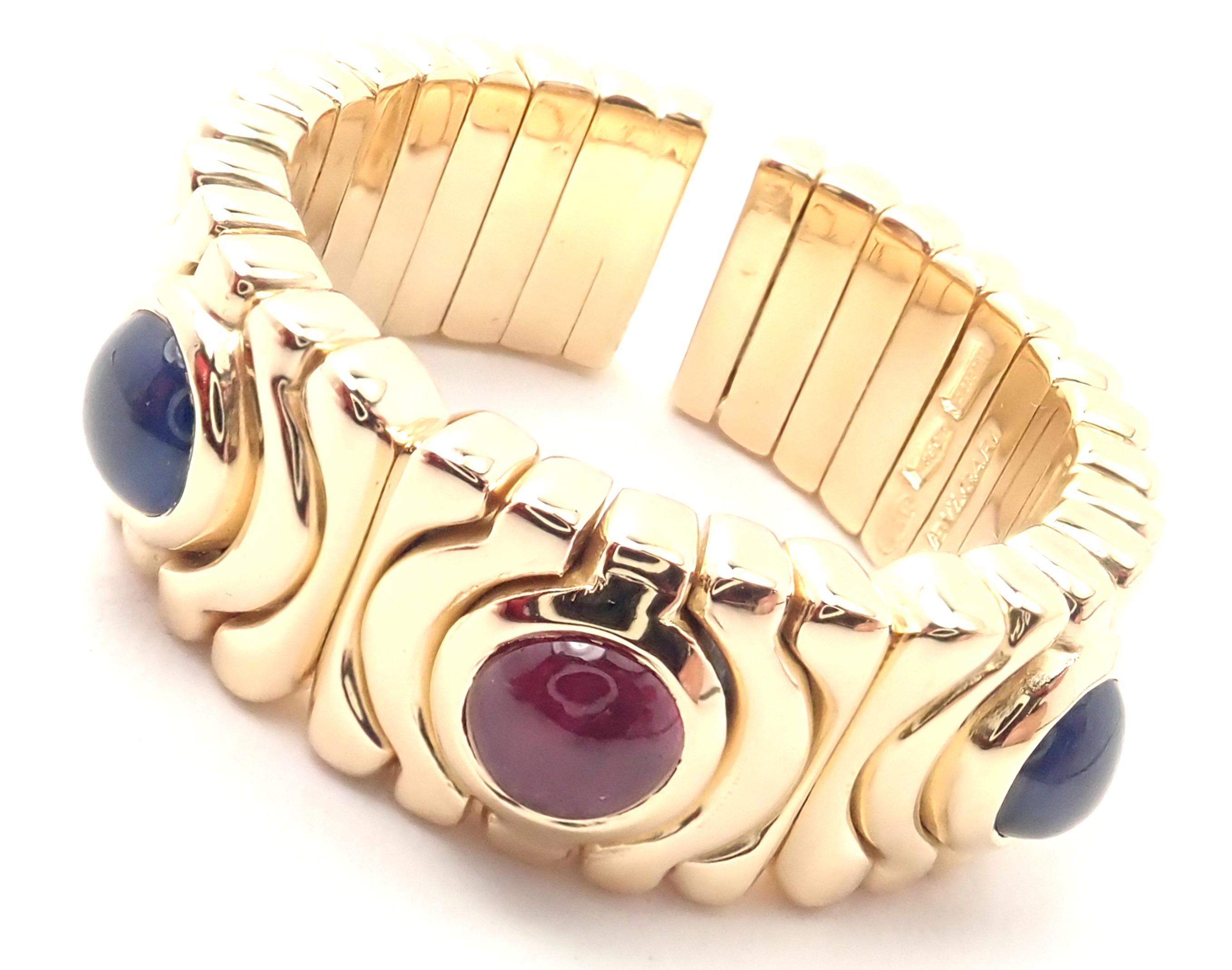 18k Yellow Gold Parentesi Sapphire And Ruby Band Ring by Bulgari. 
'With 2 Round Cabochon Sapphire 4mm each
1 Round Cabochon Ruby 4mm
Details: 
Ring Size: 7.5
Weight: 14.8 grams
Width: 8mm
Stamped Hallmarks: Bulgaria, 750, 2337AL
*Free Shipping