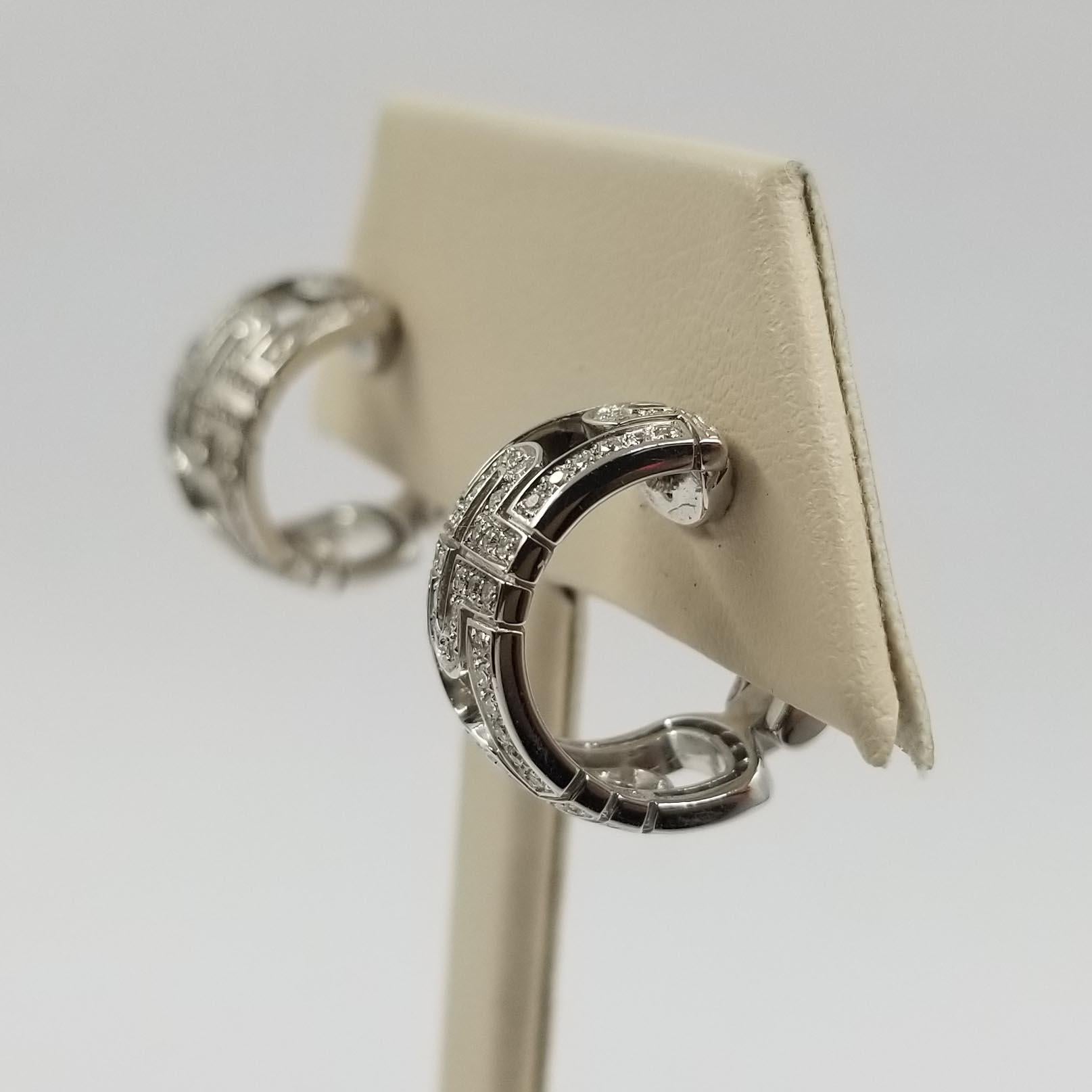 These 18 karat white gold and diamond hoop earrings are crafted by Bulgari, in their Parentensi collection. They feature approximately 0.60 carat total weight of round brilliant cut diamonds of VS clarity & G color. Earring tops are slightly angled
