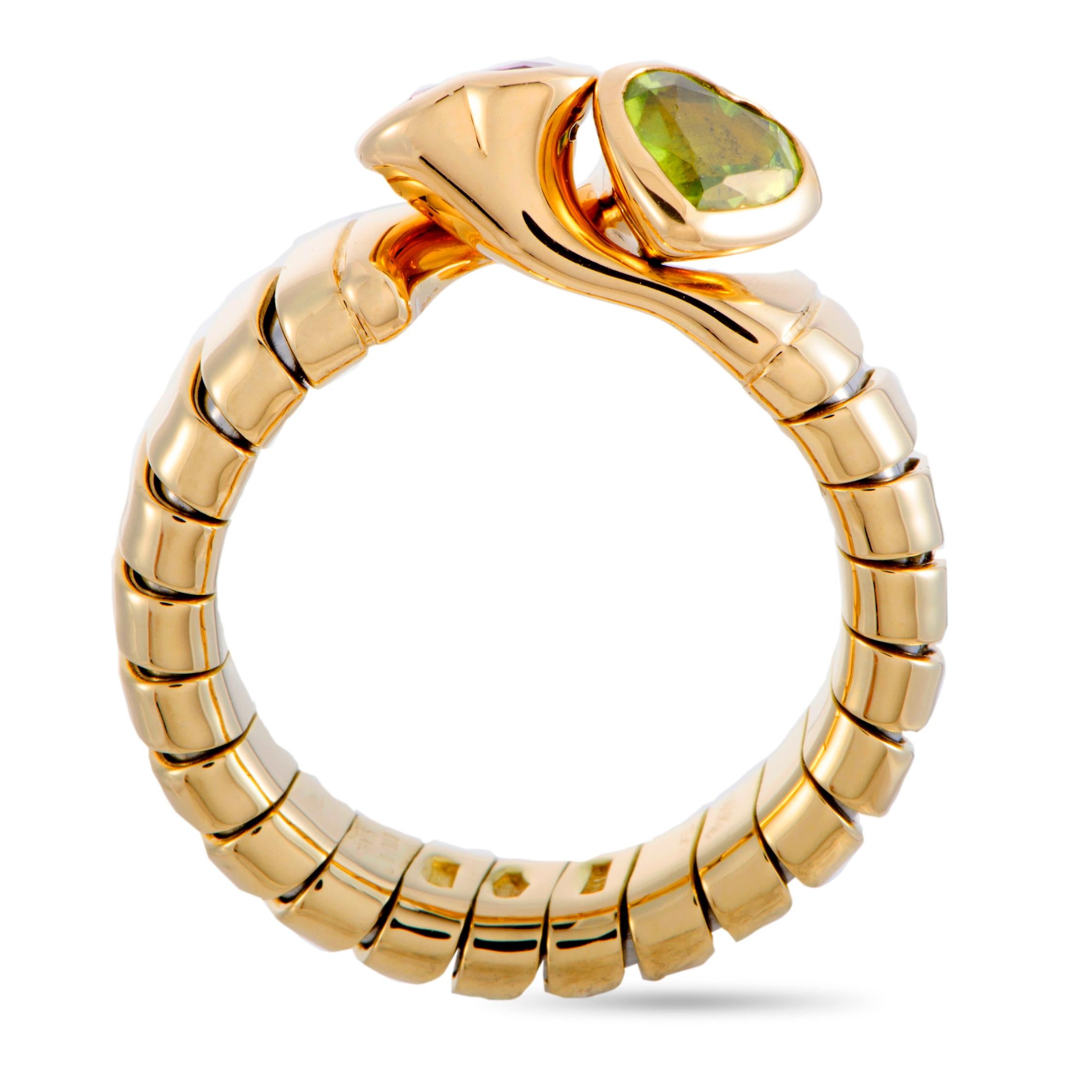 This Bvlgari ring is crafted from 18K yellow gold and set with a peridot and a tourmaline. The ring weighs 8.4 grams, boasting band thickness of 5 mm and top height of 6 mm, while top dimensions measure 8 by 11 mm.

Offered in estate condition, this