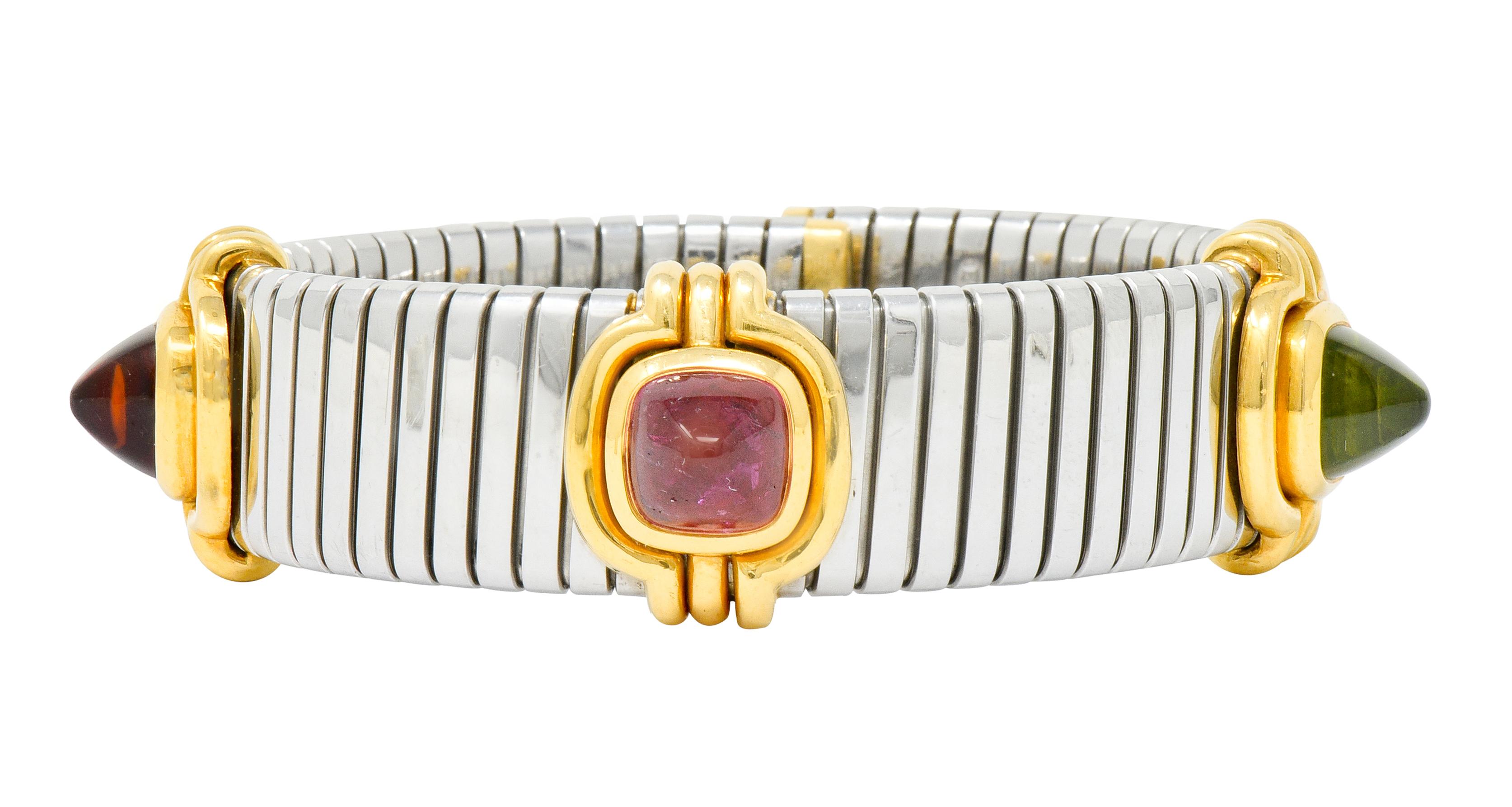 Cuff bracelet made with stainless steel tubogas technology that terminates as polished gold end caps

With three sugarloaf cabochon gemstones measuring approximately 8.5 x 8.5 mm, bezel set in polished gold surrounds featuring ribbed