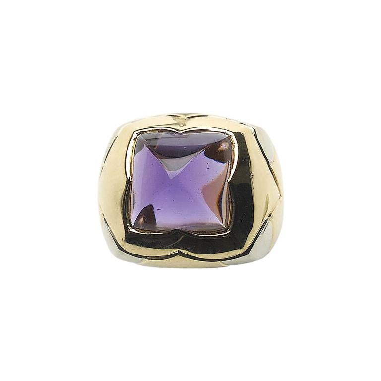 A Bulgari Piramide amethyst and gold ring, set with a sugar loaf cut amethyst, weighing approximately 8.00ct, set in 18ct yellow gold, with white gold decoration on the shoulders, signed Bulgari, with maker's mark, 9c a flower BF, Italian mark, star