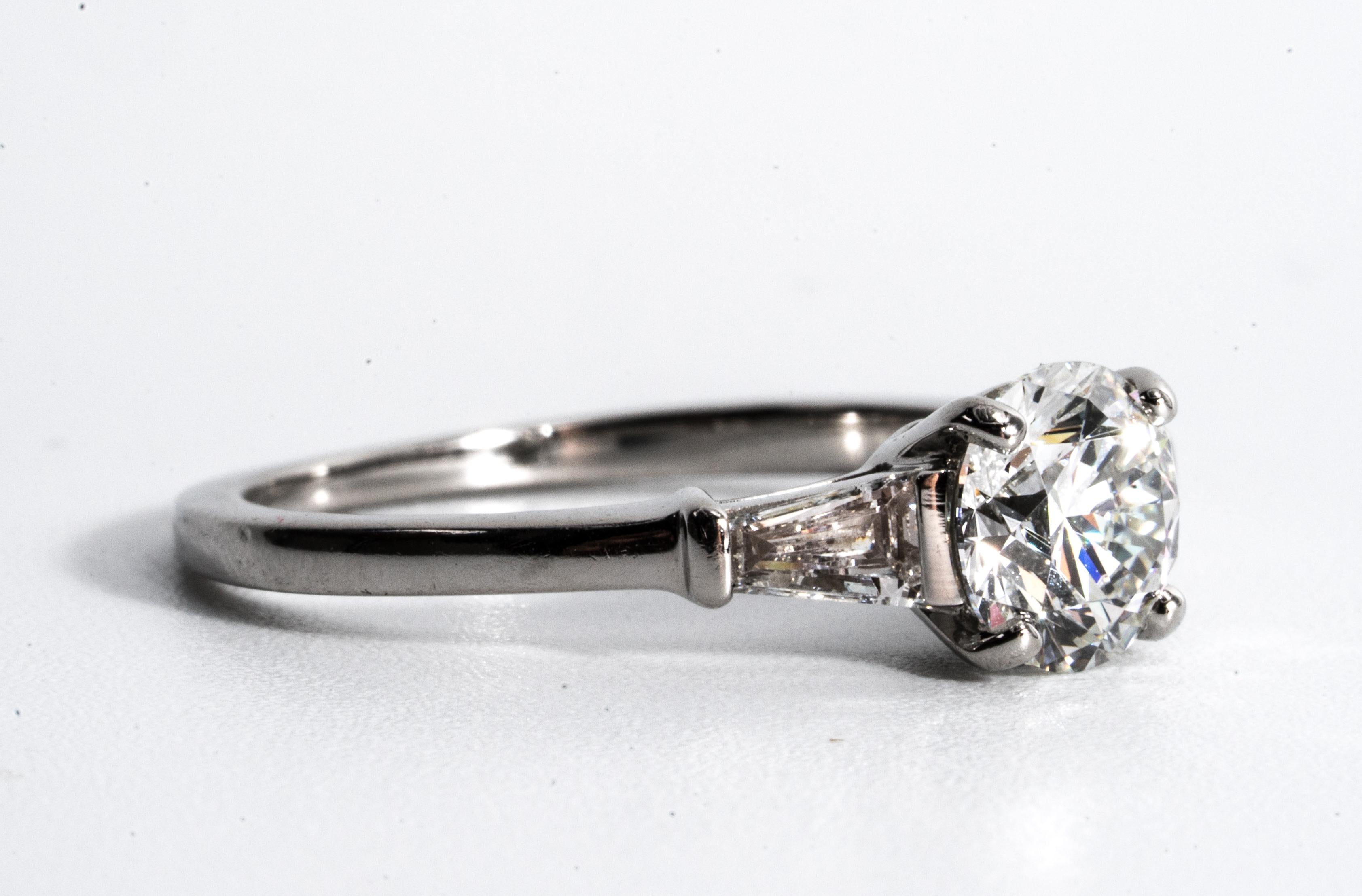 Bulgari Platinum Diamond Engagement Ring  flanked by two tapered Baguettes signed by Bulgari featuring a 1.01 ct Center, graded G color , and VVS1 Clarity.

Center: 1.01 G VVS1 
Sides: .35 Carats total tapered Baguettes - F-G VVS 

Ring is currently