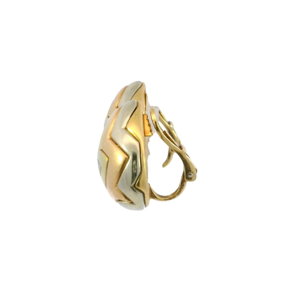 Bulgari Pyramid Geometric Earrings 18K Tricolor 1980's Clip-ons 

These stunning earrings showcase a bold geometric design, made in 18K yellow gold. Each piece features a layered motif with a central star-like shape, surrounded by concentric heart
