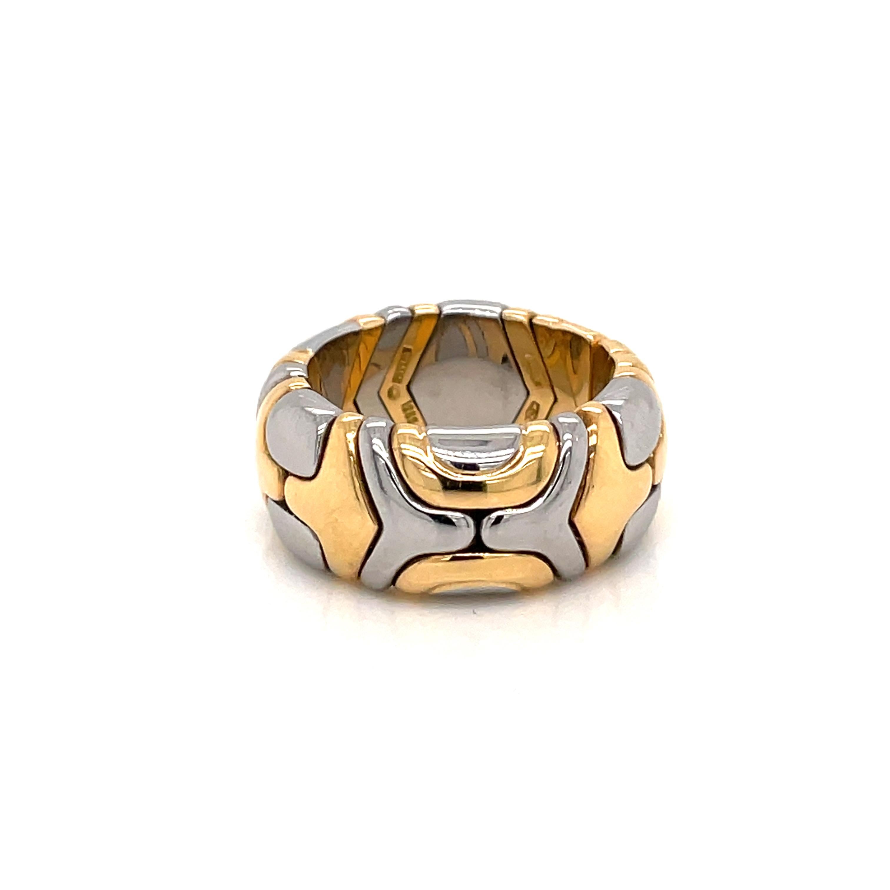 Classic Alveare ring designed by Bvlgari.

A geometric flexible Alveare ring band, crafted in Rome Italy by the house of Bulgari in two tones of solid yellow 18 k gold and steel. Dated 1980'.

Has a total weight of 12 grams. The actual size is 6,