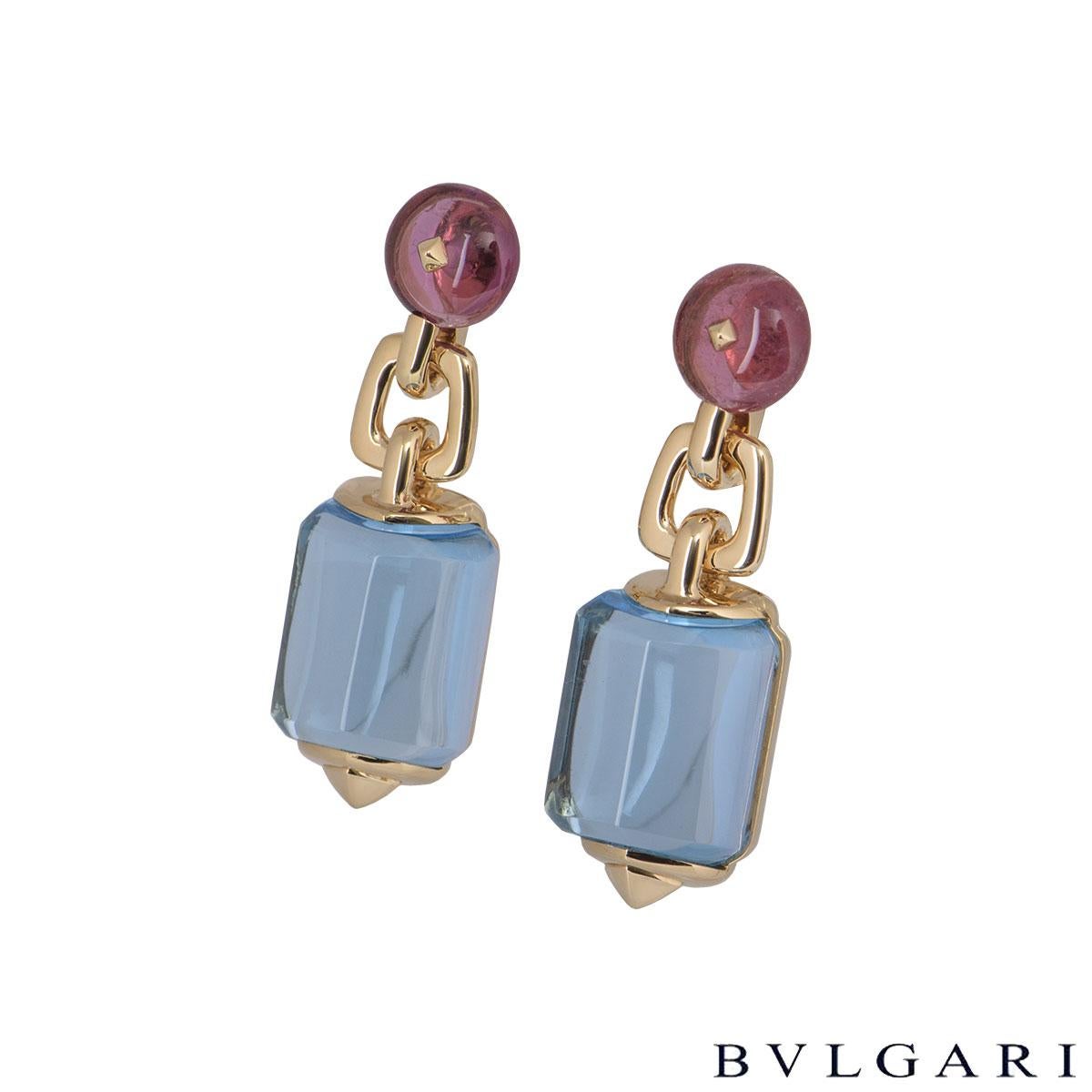 An 18k rose gold pair of earrings by Bvlgari. The earrings each comprise of a circular beaded amethyst with an aquamarine stone suspended underneath it. The earrings feature a clip on fitting with a length of 3.5cm and a gross weight of 23.48