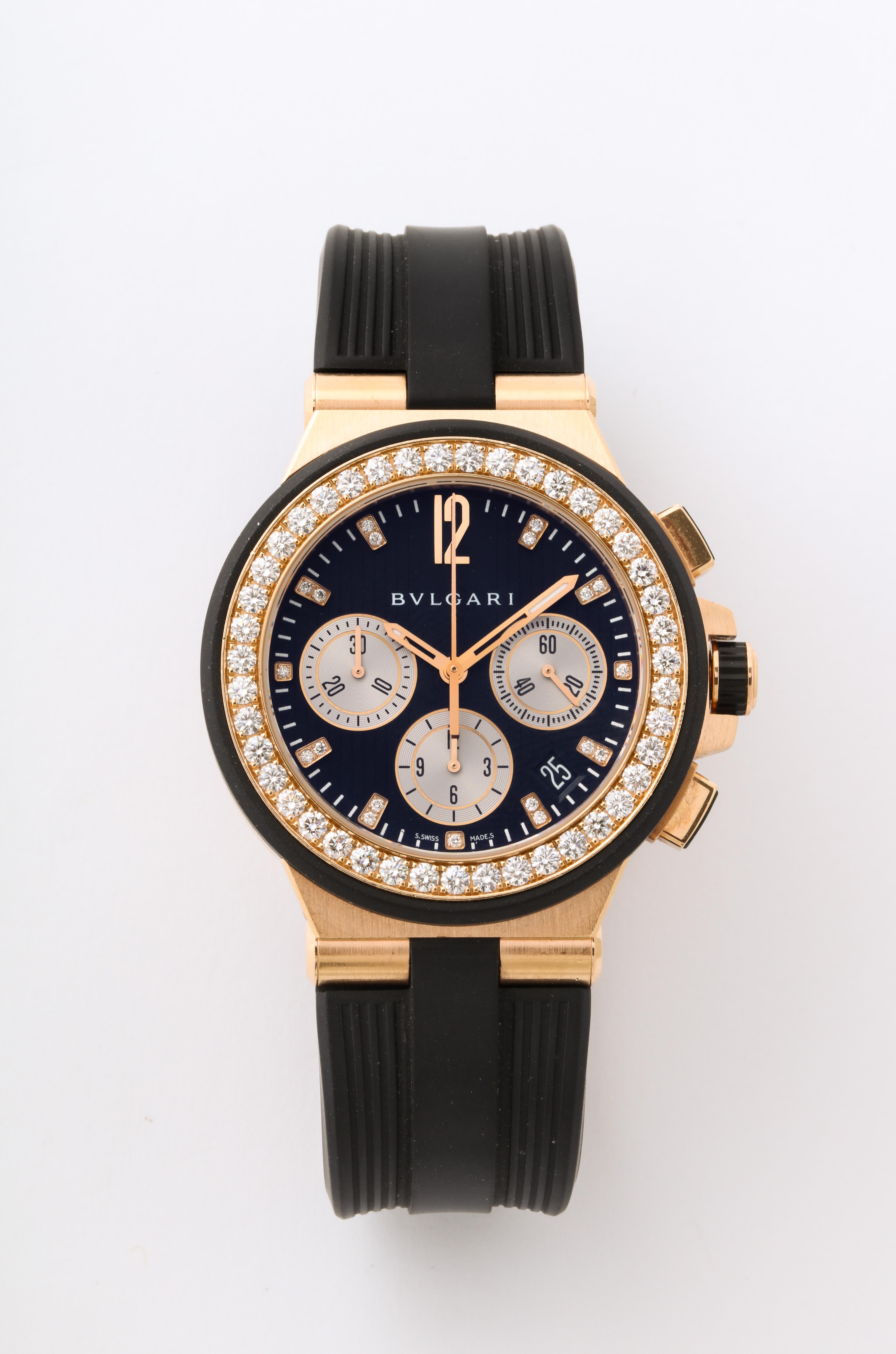 Pre-Owned Bulgari Diagono Chronograph automatic watch.
40mm 18k rose gold case with a diamond bezel and a black dial with diamond markers on a black rubber strap. 
Functions: date, chronograph, hours, minutes, and small-seconds.
Reference