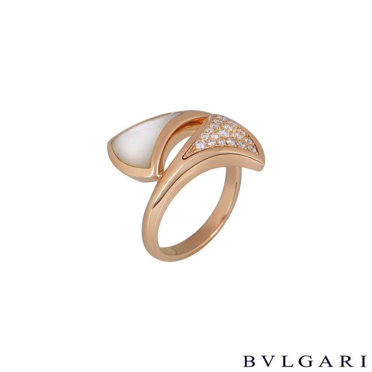 An 18k rose gold dress ring from the Divas Dream collection by Bvlgari. The ring has two triangular sections, one is pave set with 18 round brilliant cut diamonds totalling approximately 0.54ct, and the other is set with a mother of pearl inlay. The