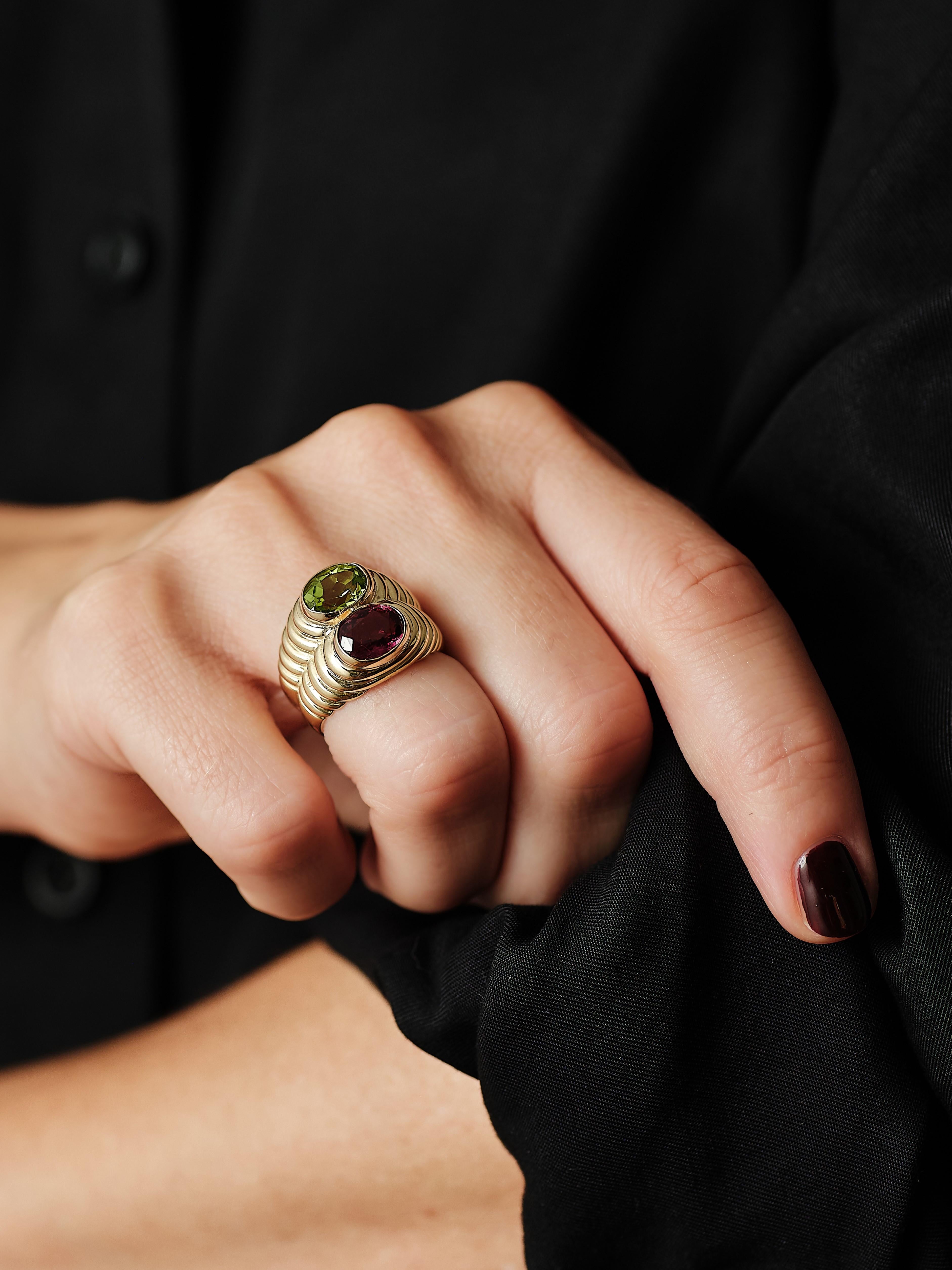 1980s Bulgari Rubellite and Peridot Doppio Ring.

Signature piece of design, created in Rome Italy by the acclaimed jewelry house of Bvlgari. This popular ring is part of the iconic doppio collection and was carefully hand-made with stepped textured