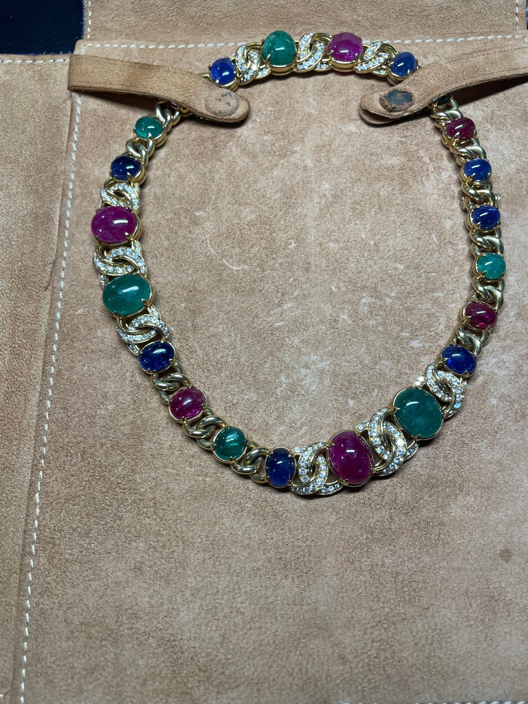 This stunning Vintage Bulgari necklace includes cabochon rubies, emeralds and sapphires framed in eclectic yellow gold and round diamonds. This particular iconic necklace was published in a similar version in 