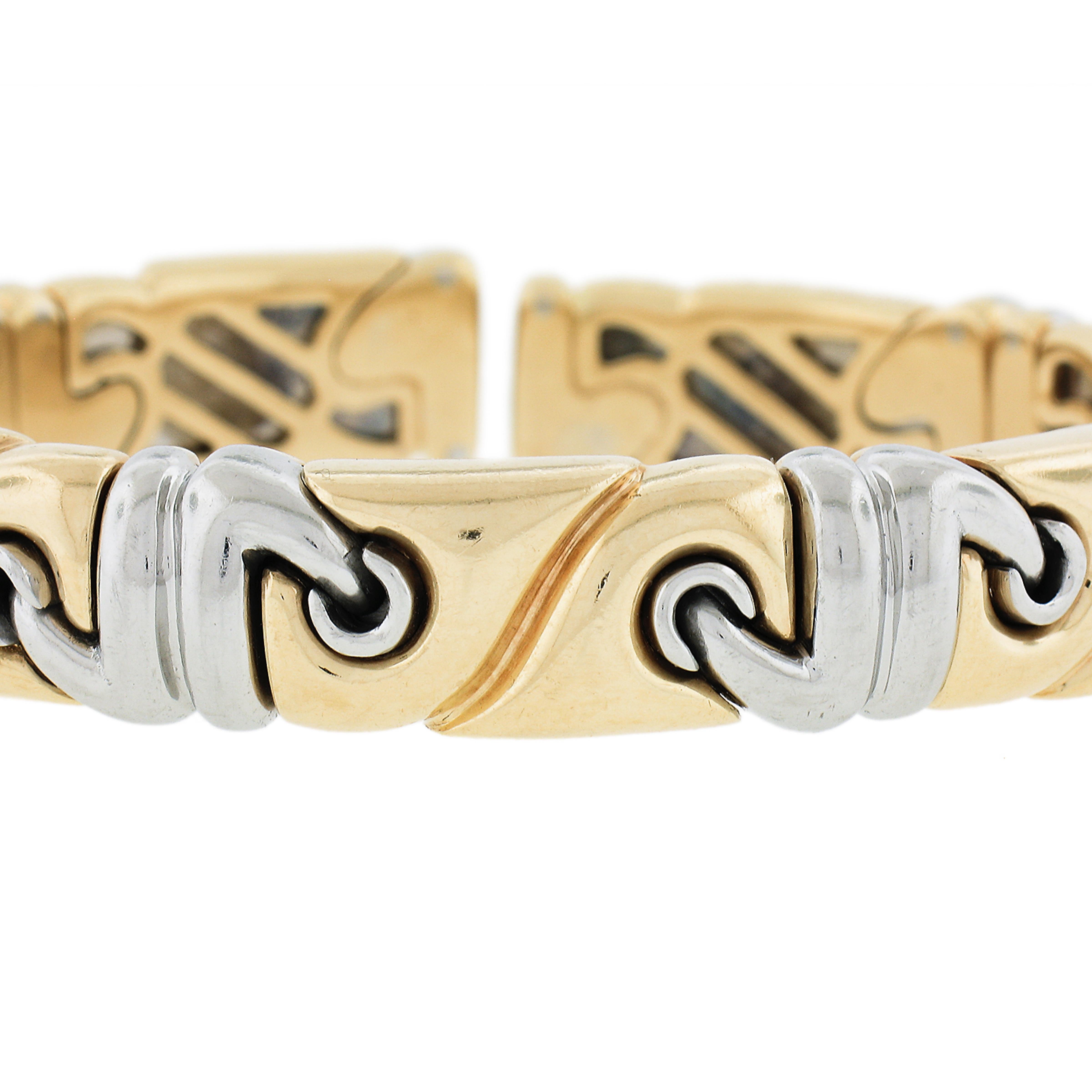 Material: Solid 18K Yellow Gold and Stainless Steel
Weight: 48.8 Grams
Type: Open Cuff Bangle
Size: Will fit up to a 6-7 inch wrist fitted on a wrist
Clasp: No Clasp  Open Cuff
Overall Width: 10.6mm 0.41 Inches 
Thickness: 5.1mm
Stamp: Bulgari  Made
