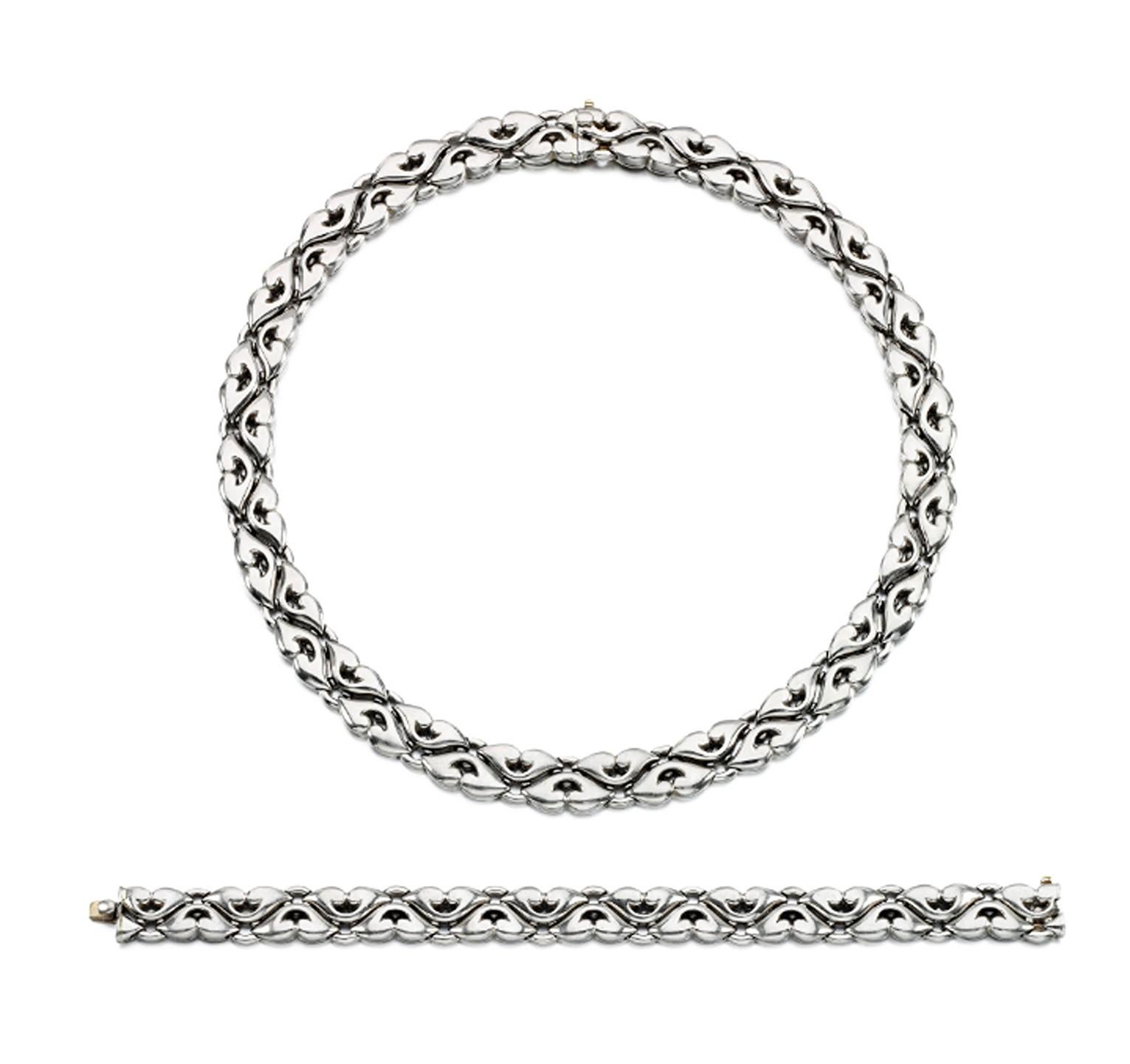 A splendid Bulgari 'Saetta' Demi Parure, comprising a necklace composed of a series of curved links, and a bracelet of similar design crafted in 18k white gold. 
Made in Italy, circa 1980.

Necklace inner circumference: approx. 460mm
Bracelet
