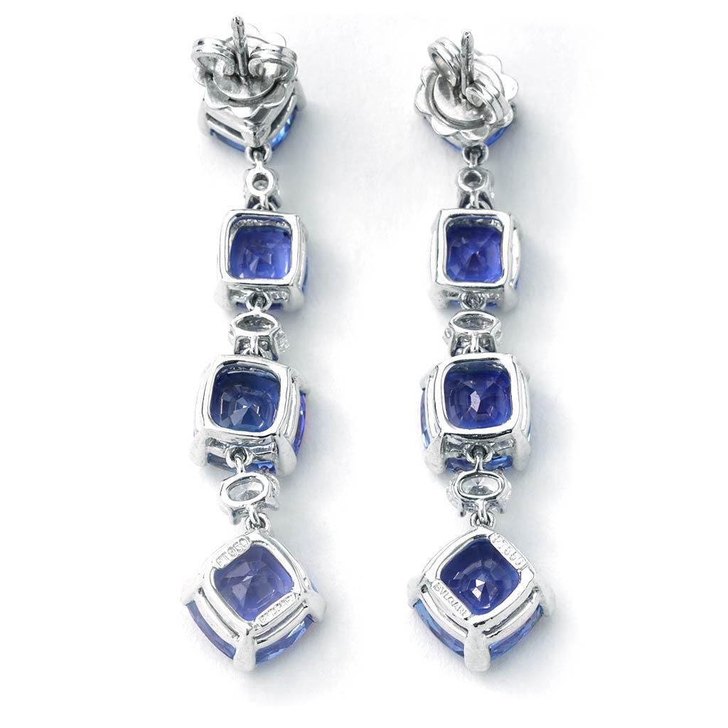 Previously-owned Bulgari Sapphire and Diamond earrings. The pair of earrings is 1.5 inches in length, made of 18K white gold and platinum, and weighs 9.20 DWT (approx. 14.31 grams). It also has eight cushion sapphires weighing 17.62 CTTW, and six