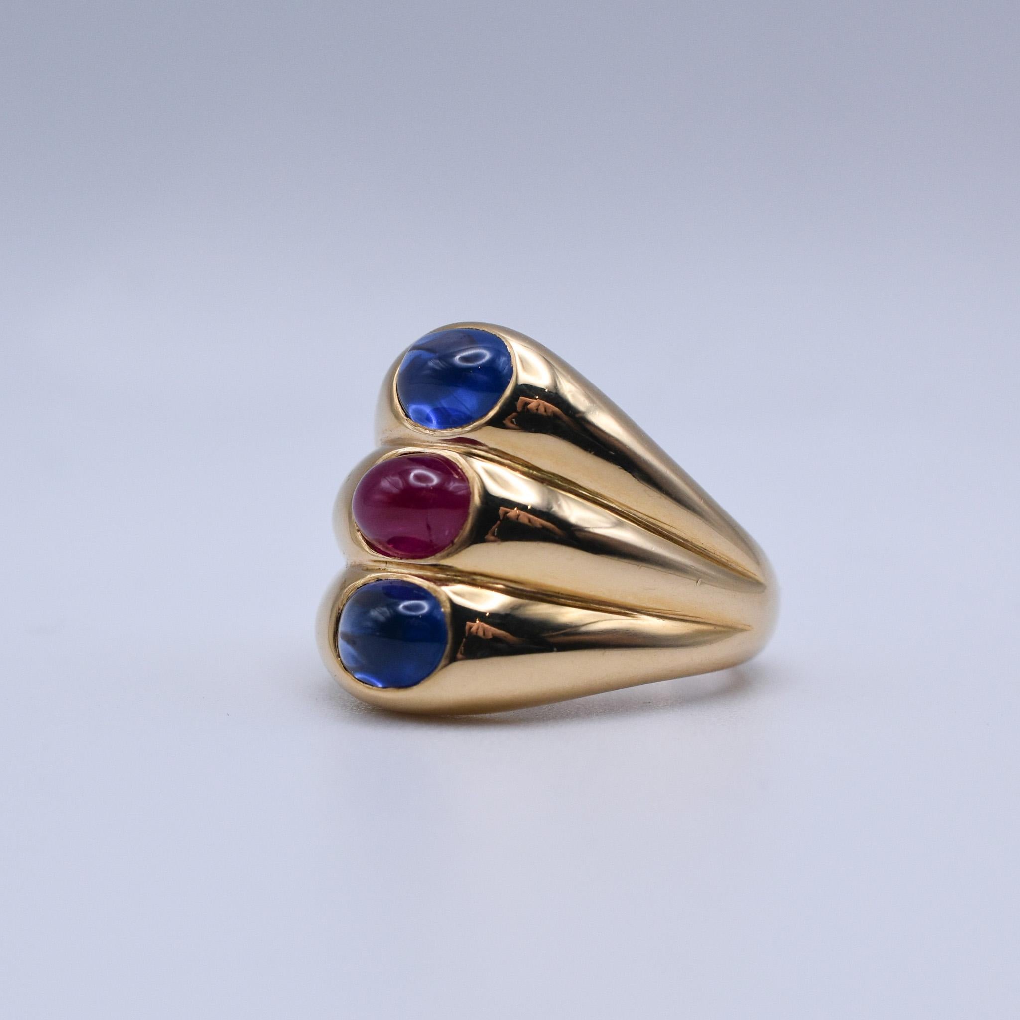 Bulgari Dome Shaped Ring crafted in 18k yellow gold, showcasing two blue cabochon sapphires and one cabochon ruby. Made in Italy, circa 1970.

Ring size: US 6.5