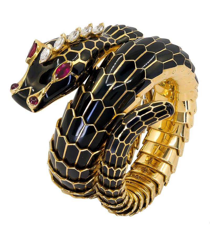 Bulgari Serpenti Black Enamel Bracelet in 18k Yellow Gold.

The iconic Bulgari Serpenti bracelet dating from the 1970s with black enamel scales and ruby accents.

Diamond weight approx. 0.40 carats total. Adjustable memory spring fits most wrist
