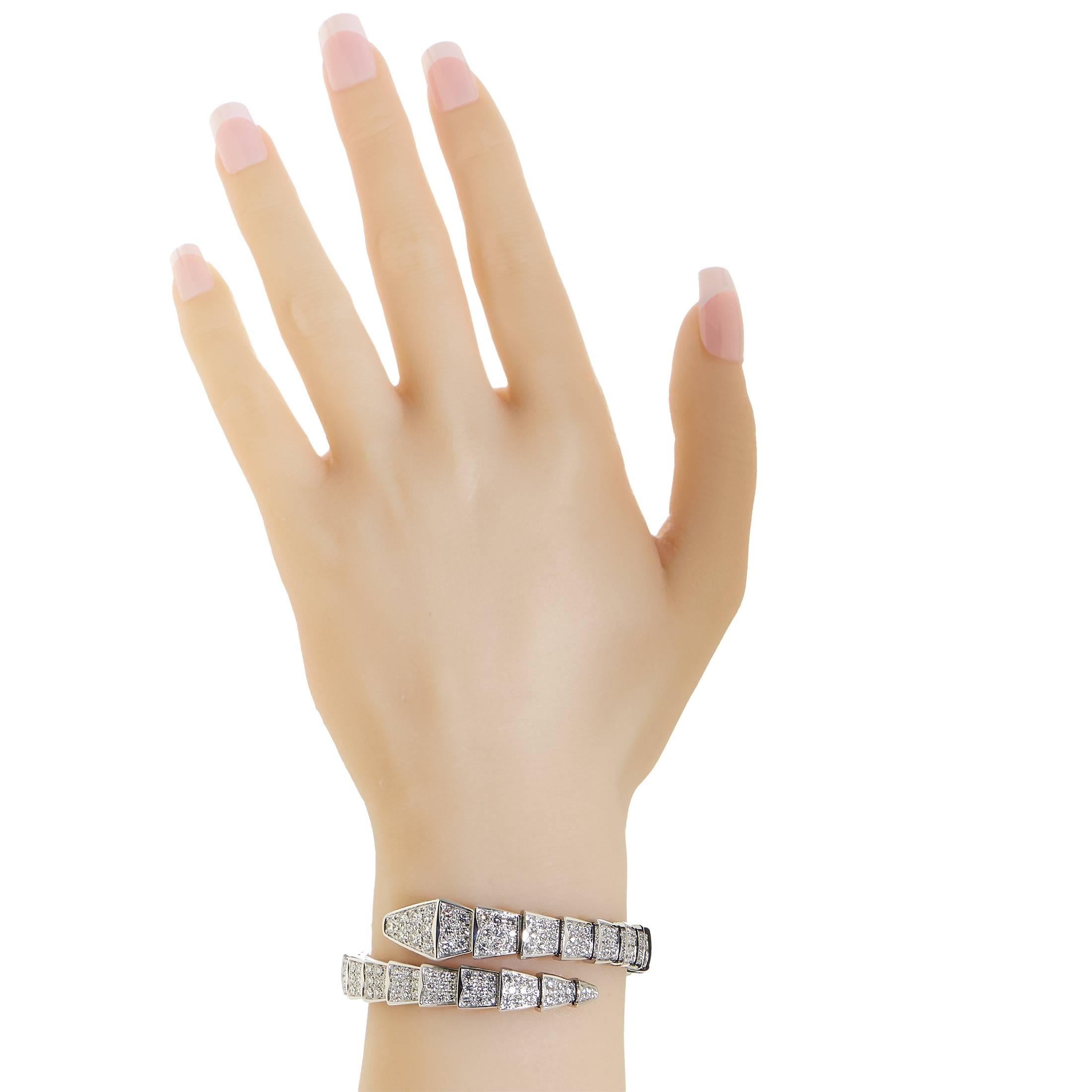Stripped down to its essence and presented in a wonderfully bright combination of shimmering 18K white gold and dazzling diamonds, the fascinating beauty of a serpent's graceful form is translated onto your wrist in this intriguing bracelet from