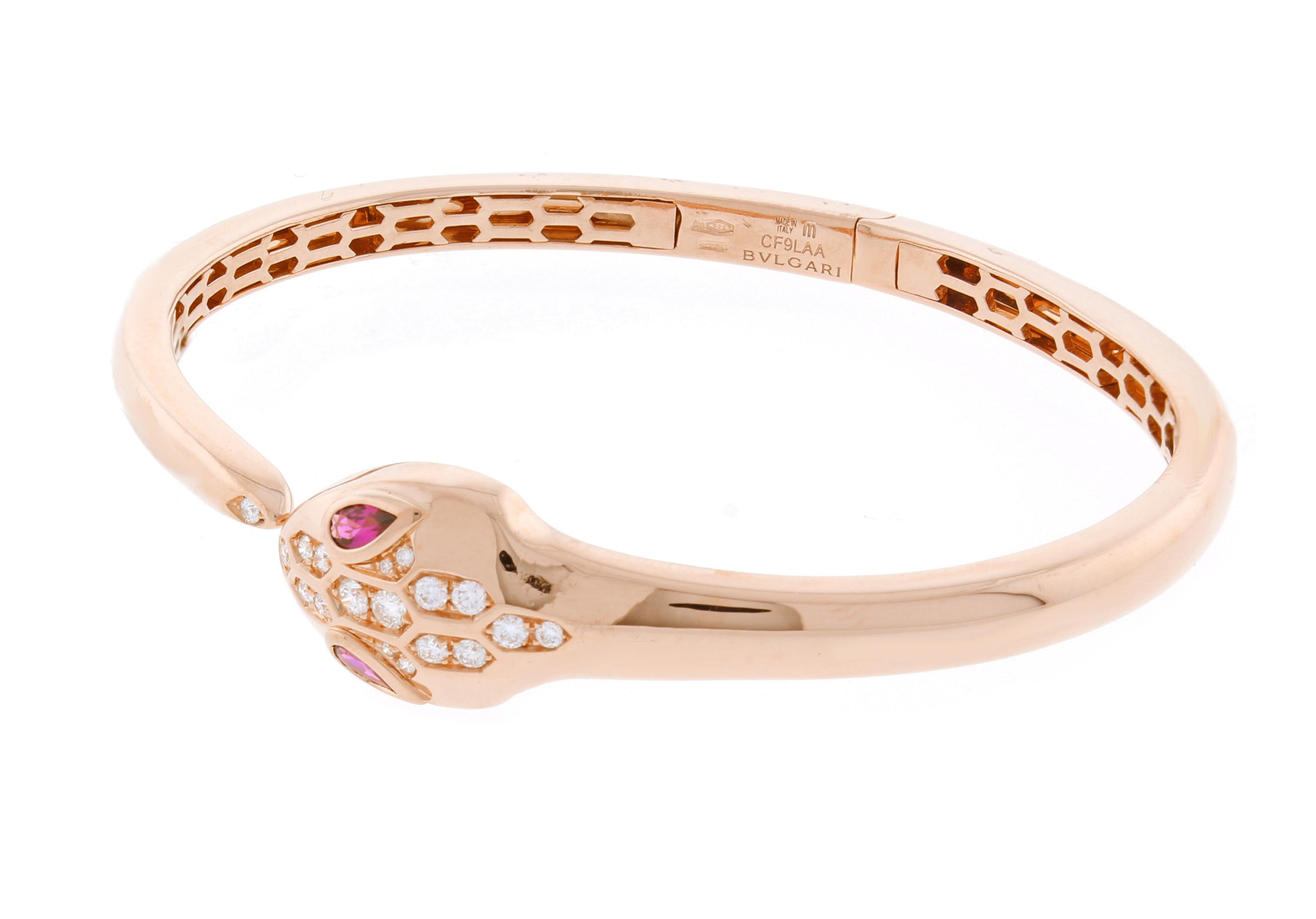 From Bulgari's Serpenti collection thier snake bracelet in 18 karat rose gold, set with rubellite eyes and demi pavé diamonds on the head and the tail.
♦ Designer:  Bulgari
♦ Metal:  18 karat rose gold
♦ Gem stone: 18 Diamonds=.45 carats
♦ Gem