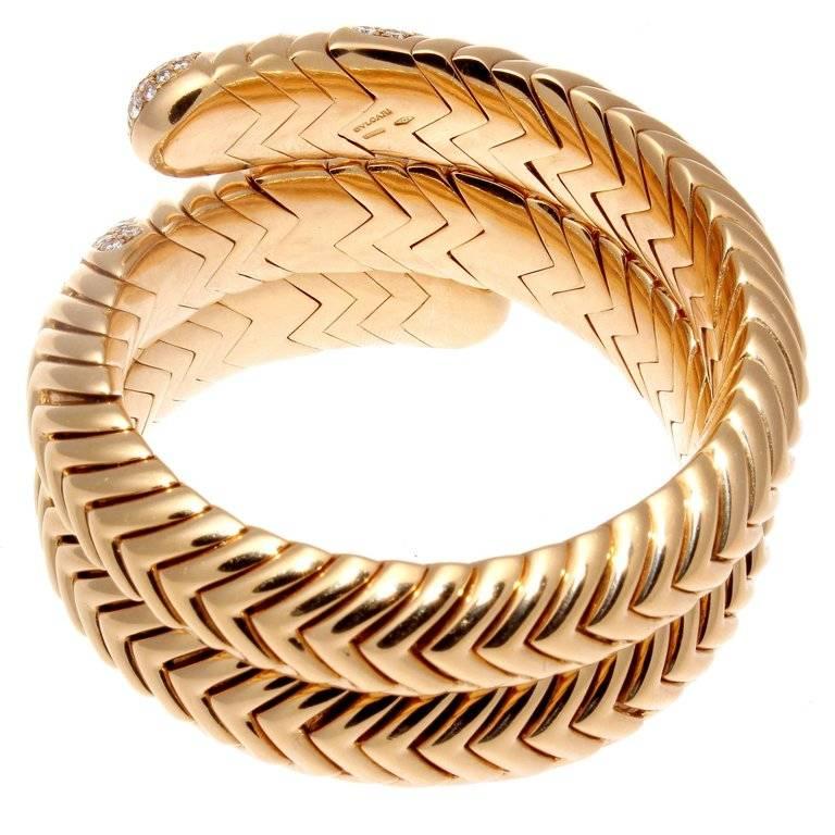 Iconic design from the Spiga collection that is pure Bulgari. Featuring 138 diamonds weighing approximately 3.50 carats that are D-E color, VVS clarity. Designed in rolling contours of glistening 18k yellow gold that coils around the wrist. Weighs
