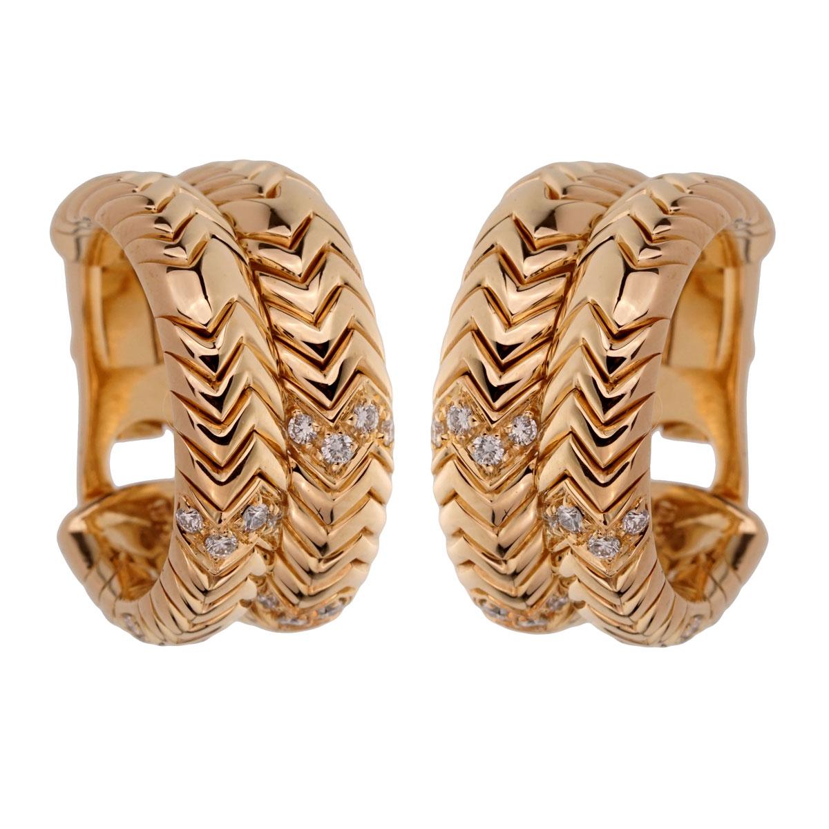 An iconic set of authentic Bulgari Spiga earrings adorned with round brilliant cut diamonds in shimmering 18k yellow gold.