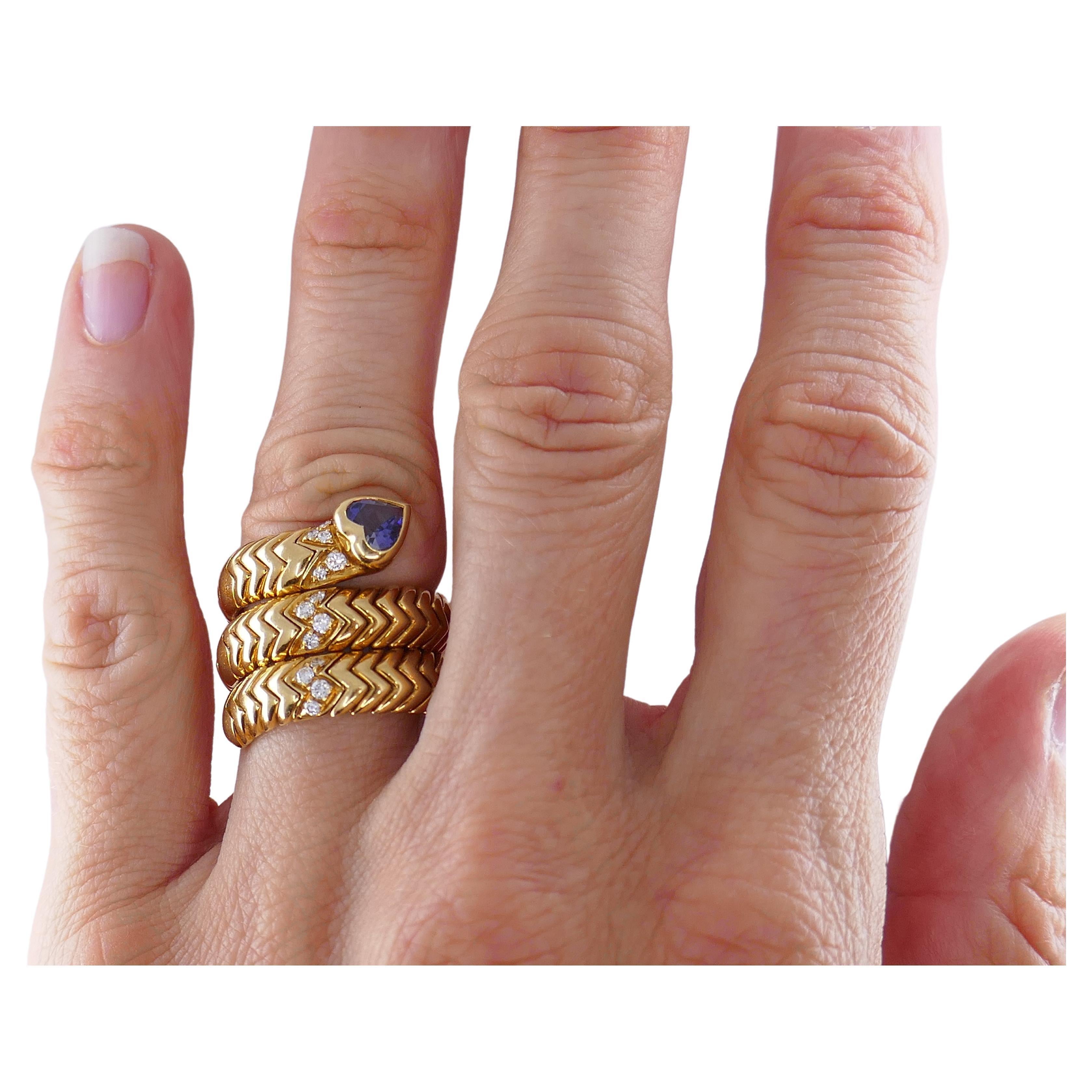 An iconic Bulgari Spiga ring, with diamonds and a heart-shaped sapphire.
A glossy, three rows wrap-around ring with a famous Spiga pattern is simply a perfection. Sparkly diamonds add a pinch of glamour to the look. And a heart-shaped sapphire turns